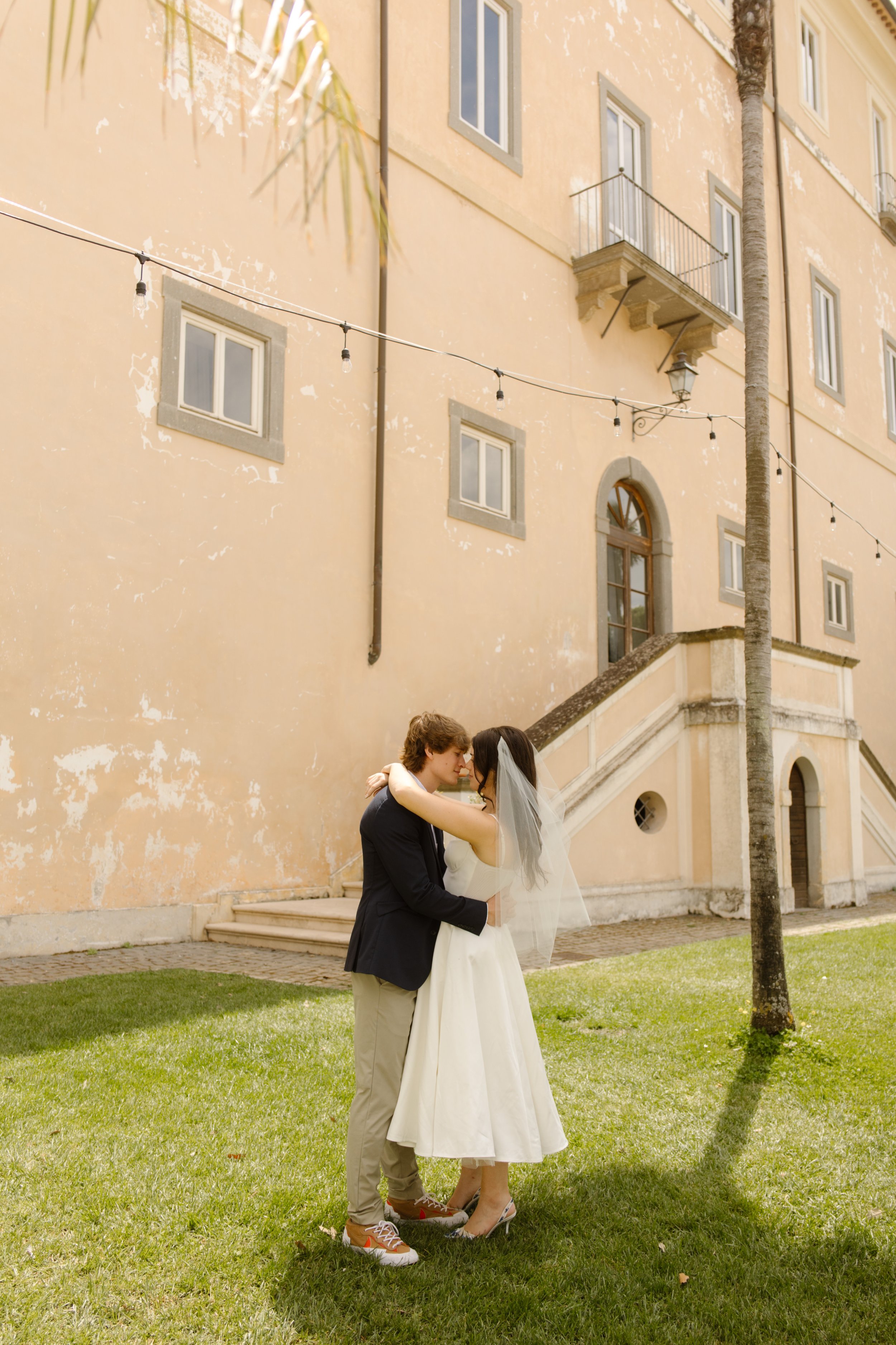 Newlywed couple embracing outside a historic villa during their Multi-Day Destination Wedding