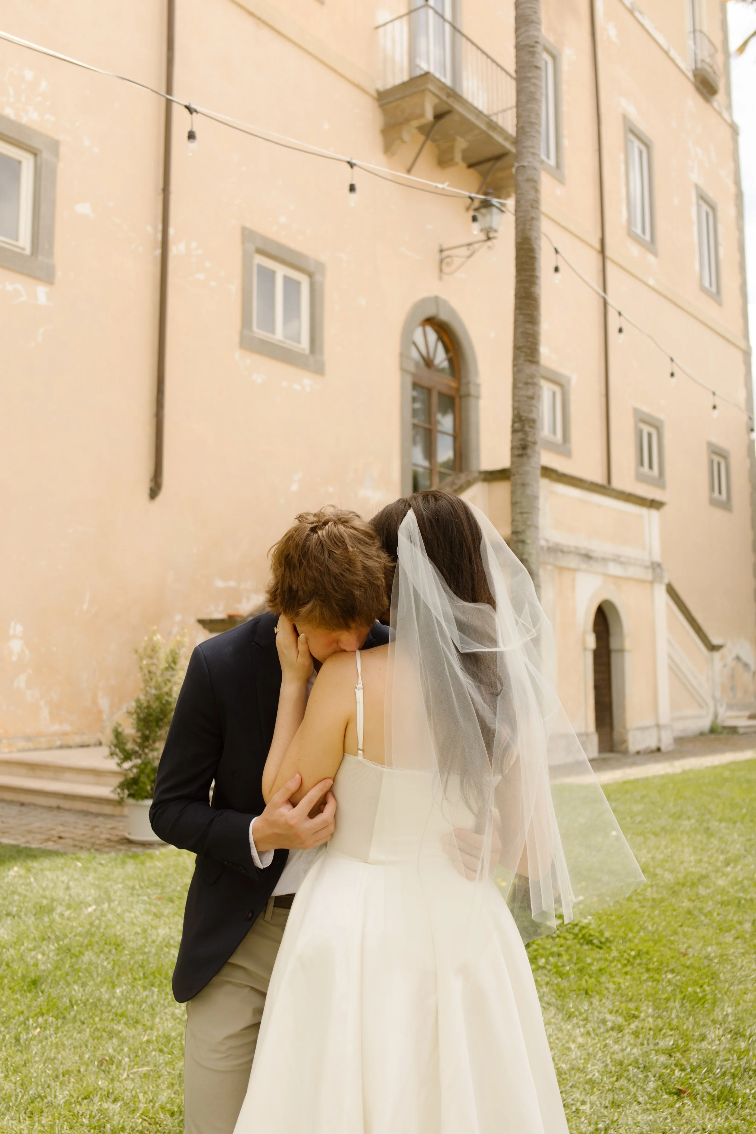 Newlywed couple sharing an intimate embrace outside a villa during their Multi-Day Destination Wedding