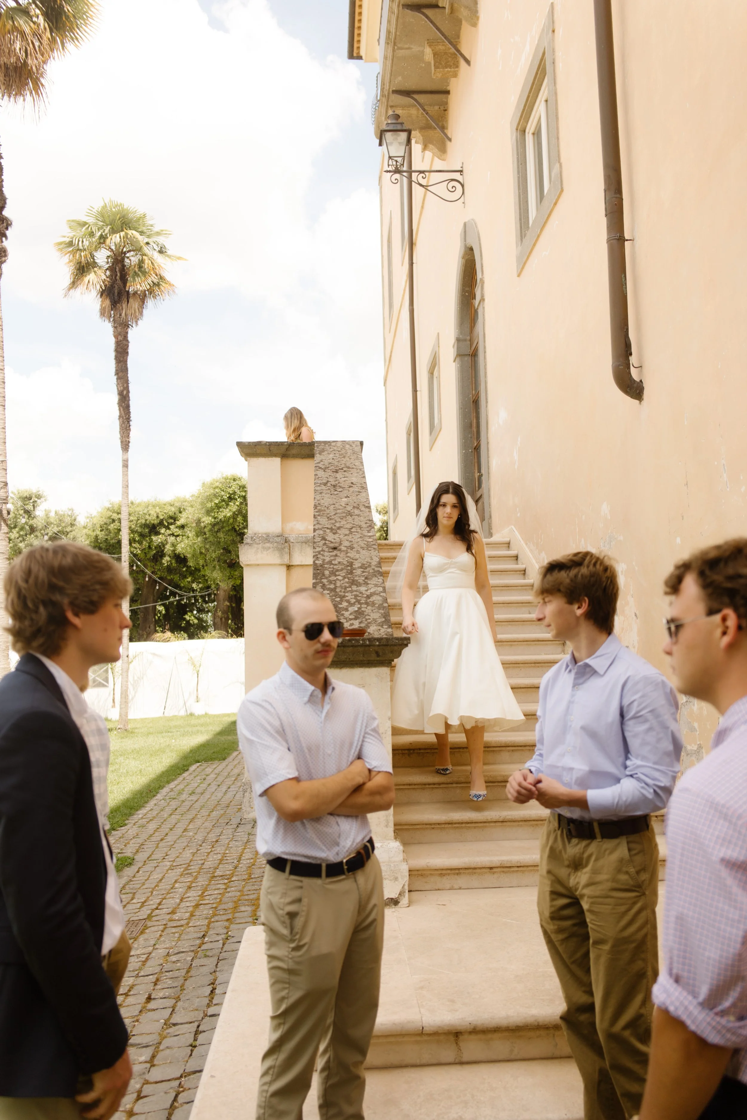 Bride walking down the steps of a historic Italian villa during her Multi-Day Destination Wedding