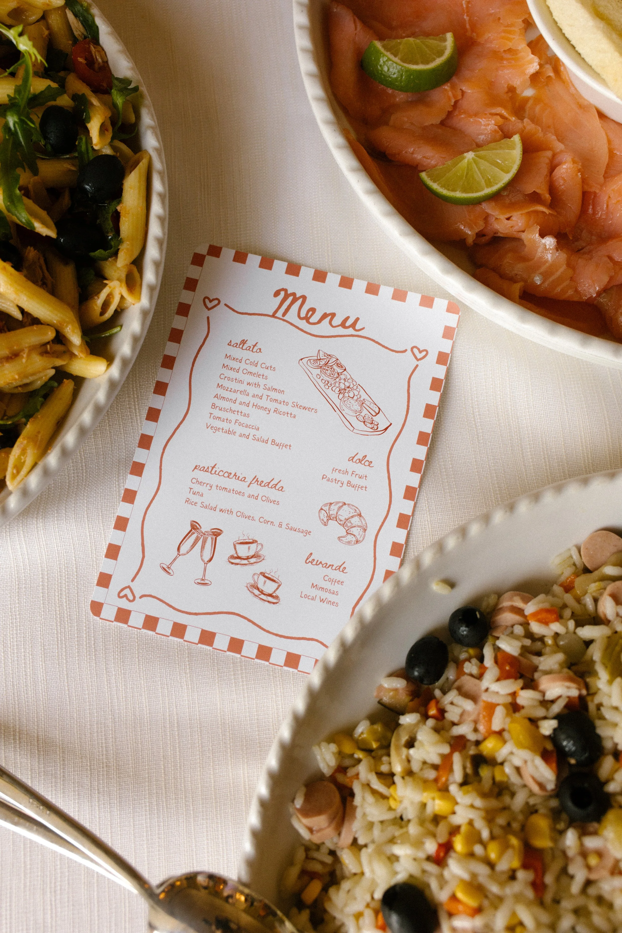 Custom menu surrounded by colorful dishes during a Multi-Day Destination Wedding welcome meal