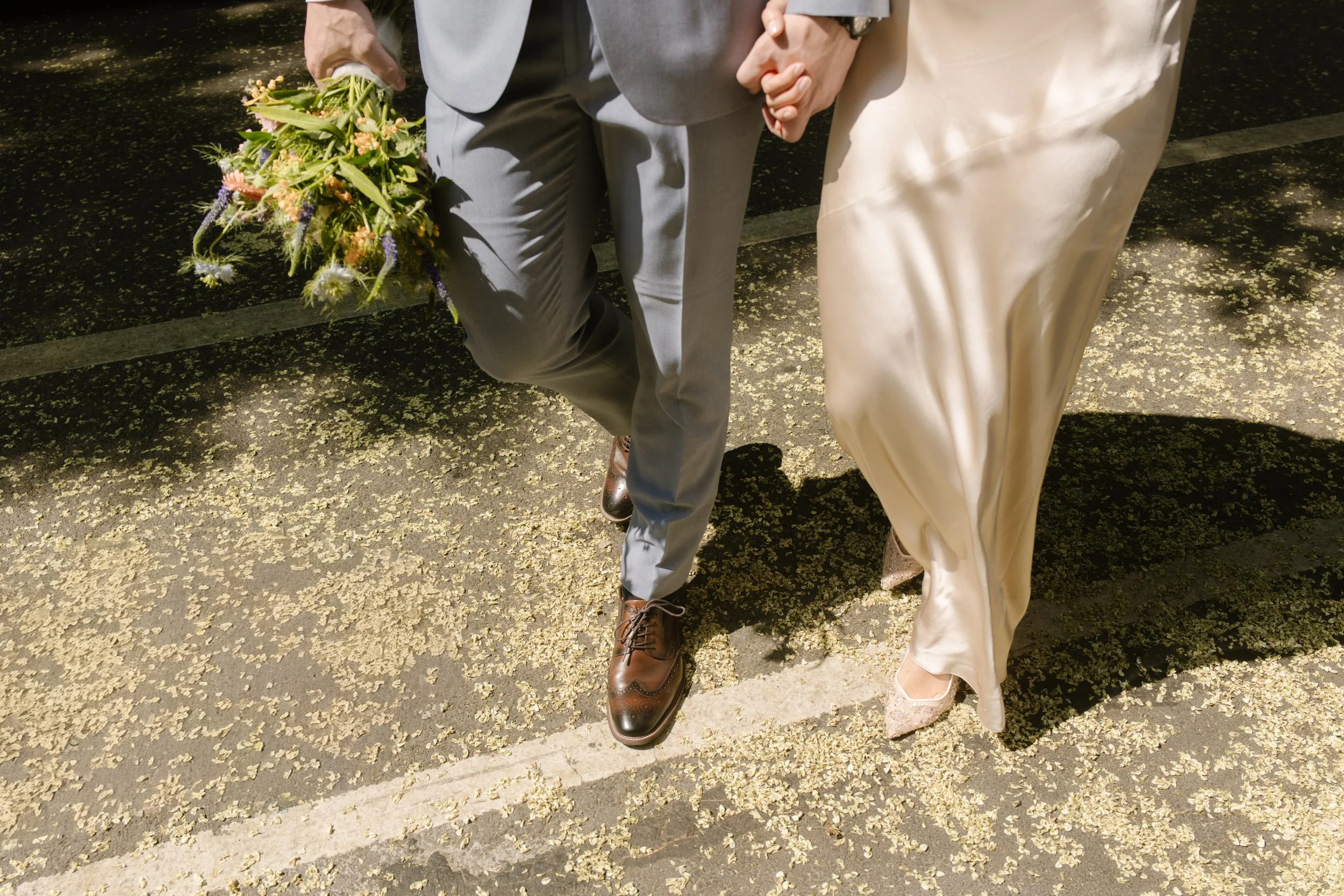 Newlywed couple walking hand in hand through Central Park during their Multi-Day Destination Wedding in New York