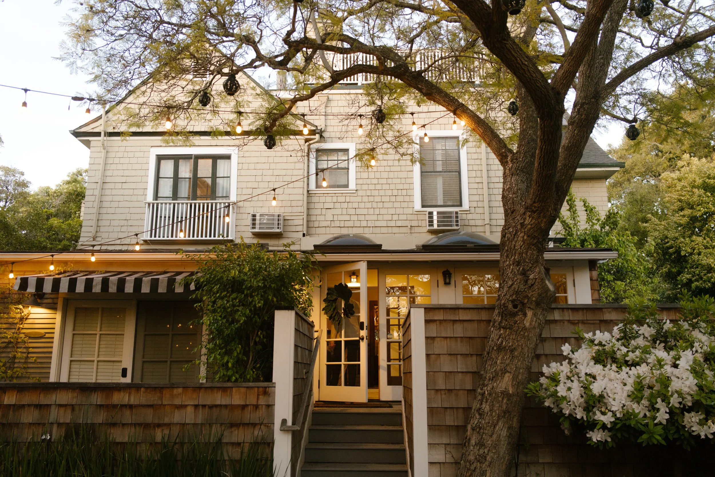 Charming wedding weekend house decorated with string lights for an intimate destination wedding gathering