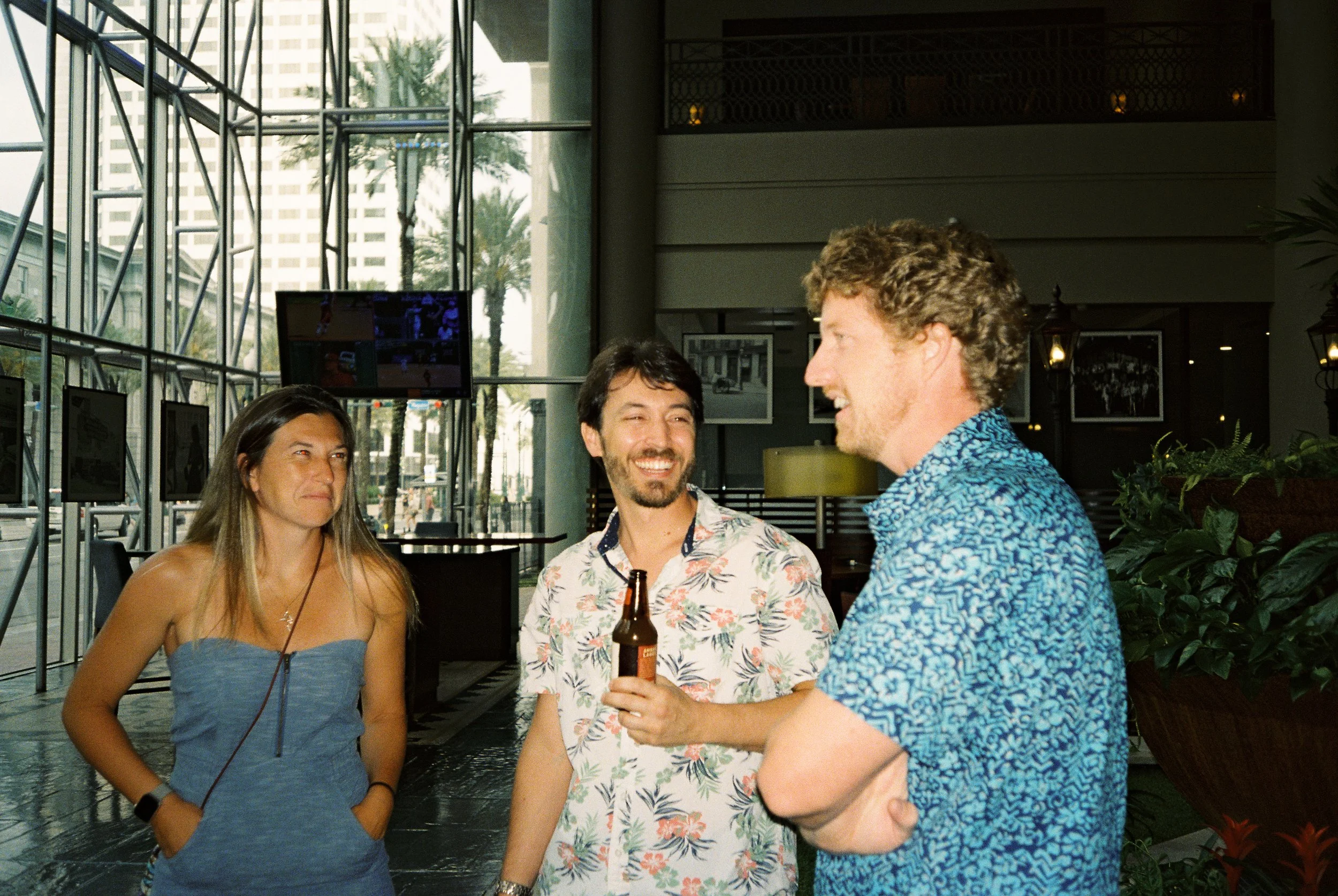 Friends chatting over drinks during a casual pre-wedding celebration.
