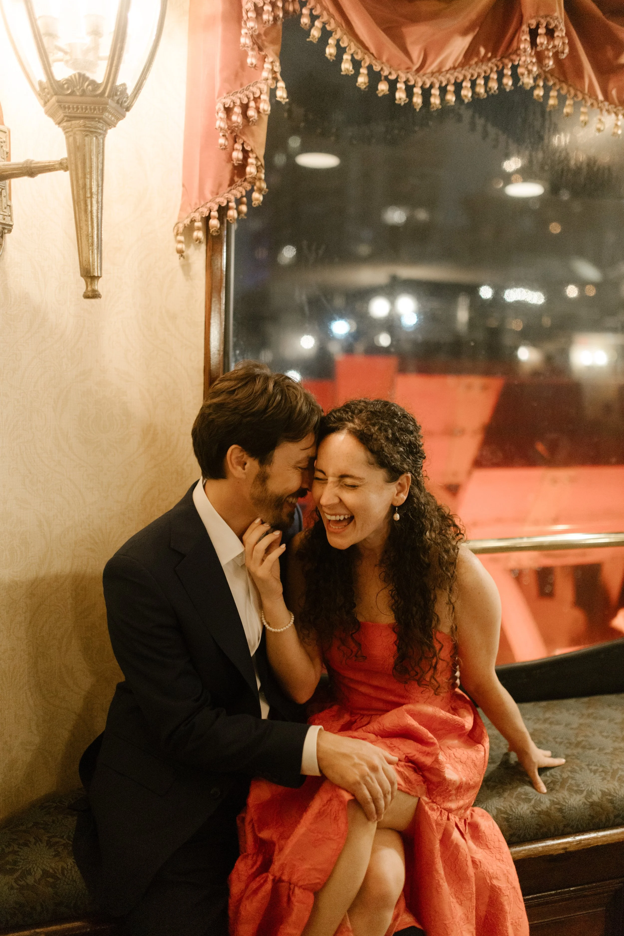 Couple sharing a playful, intimate moment together during their pre-wedding celebration.