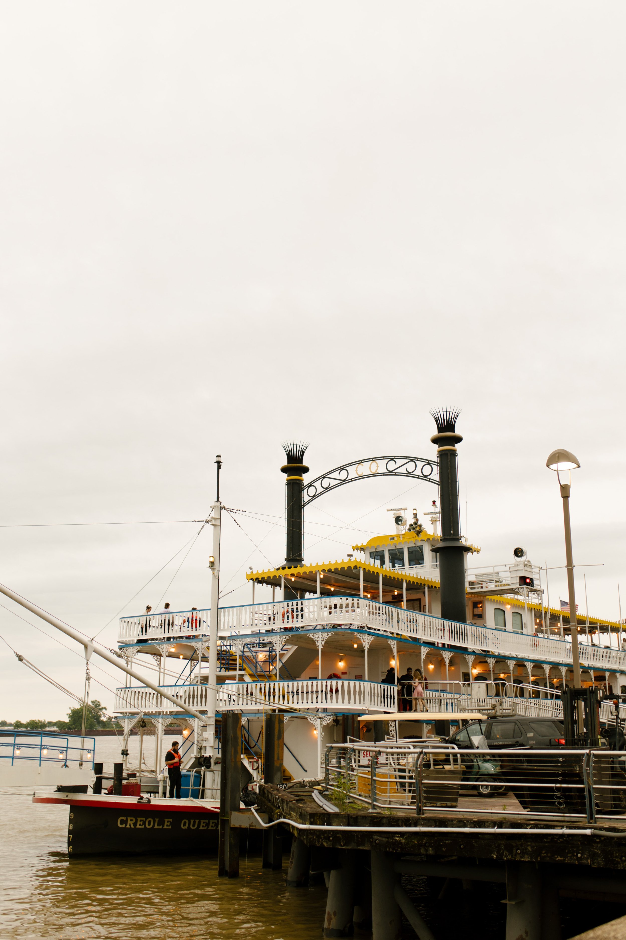 The Creole Queen riverboat docked along the waterfront, the setting for the wedding rehearsal dinner celebration.