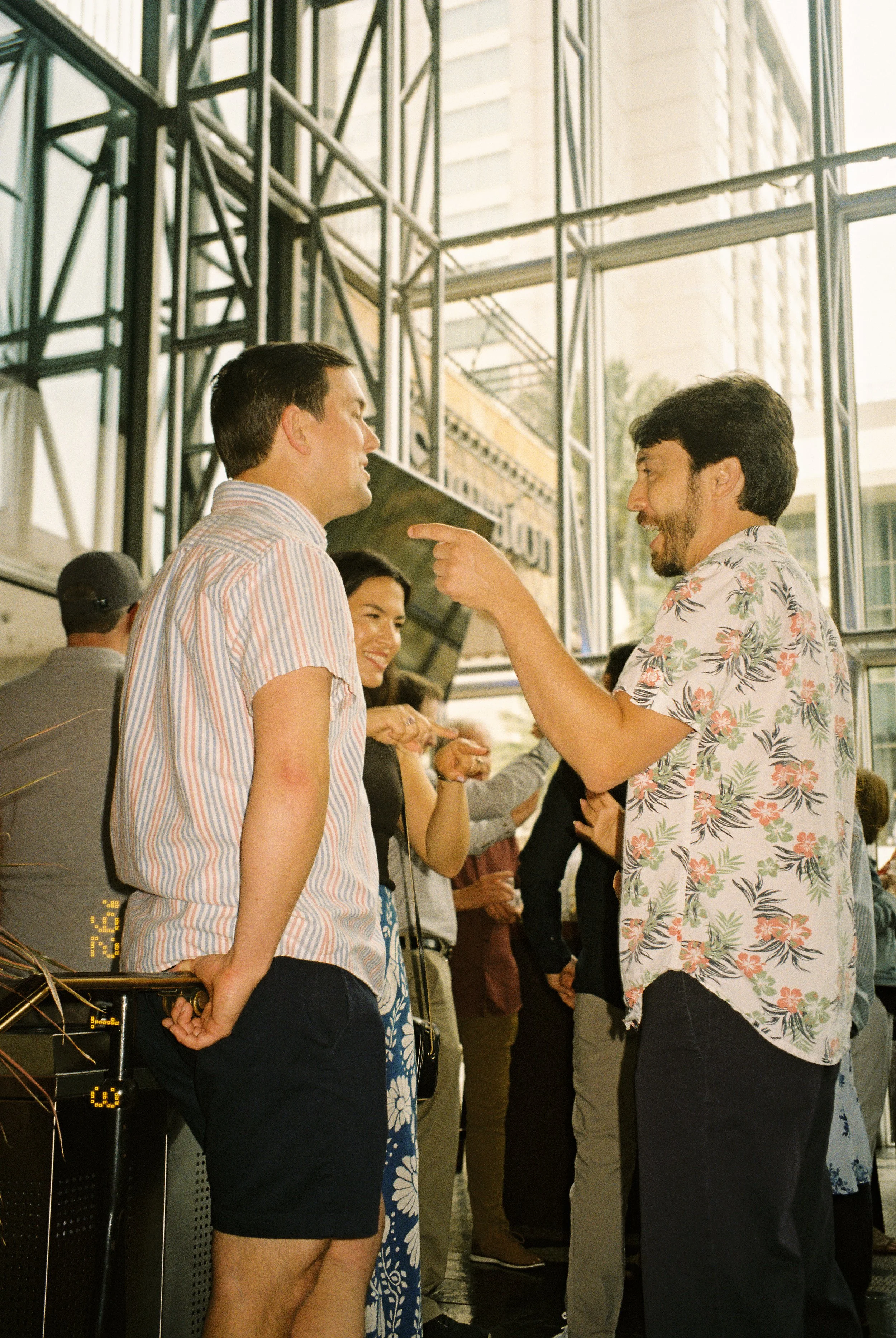 Two guests laughing and talking together during a lively cocktail hour before dinner.