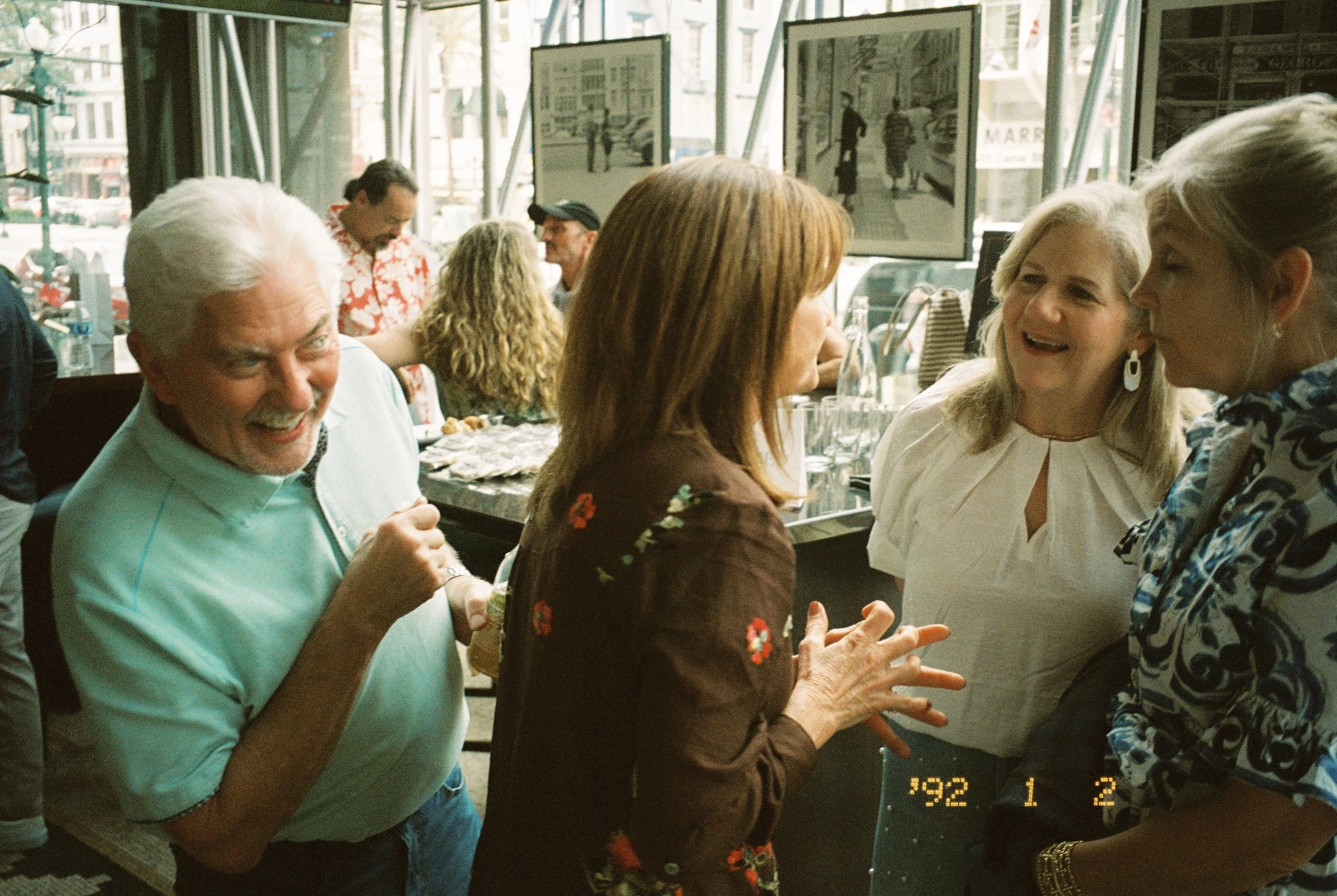 Family members laughing and catching up together during the pre-wedding gathering.
