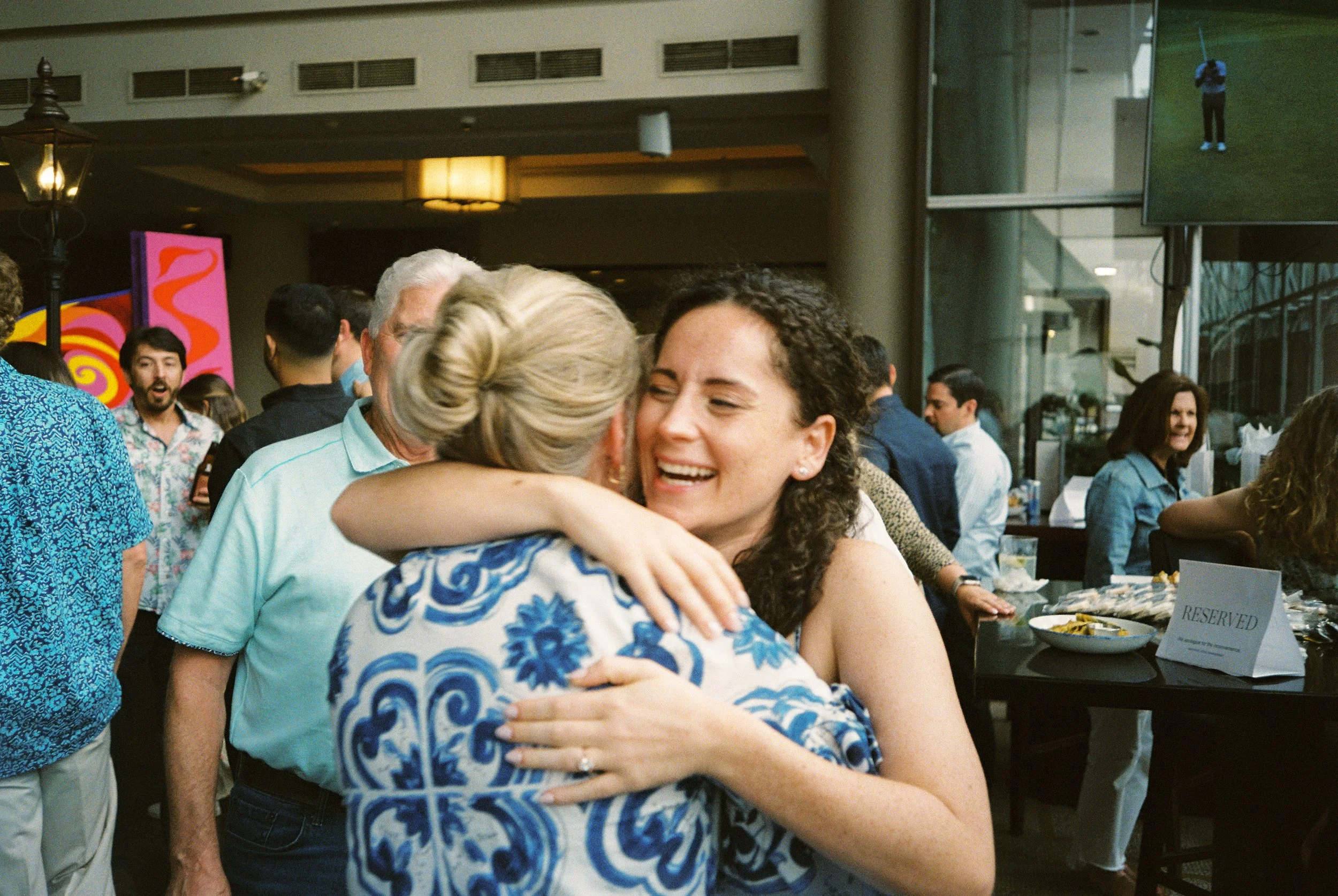 Bride-to-be smiling as she embraces a family member during the pre-wedding festivities.