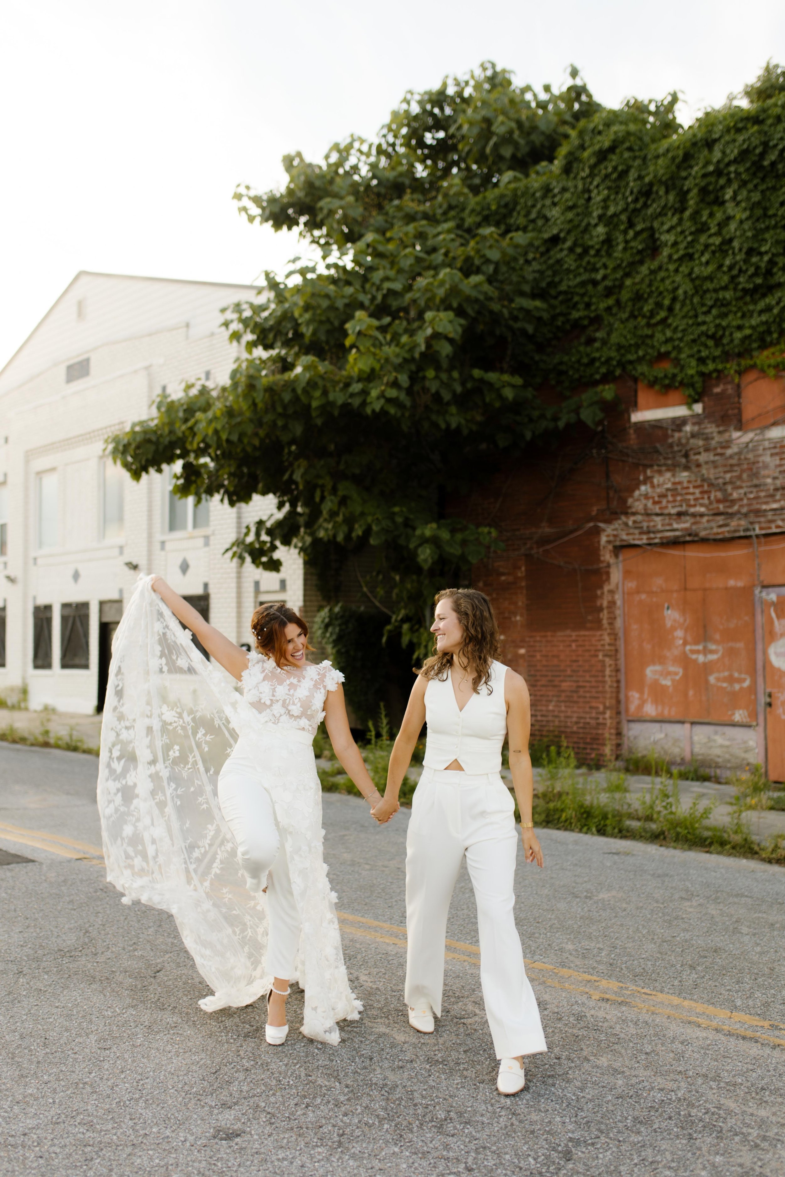 New York City courthouse wedding couple holding hands in the street wearing a lace wedding dress and white suit