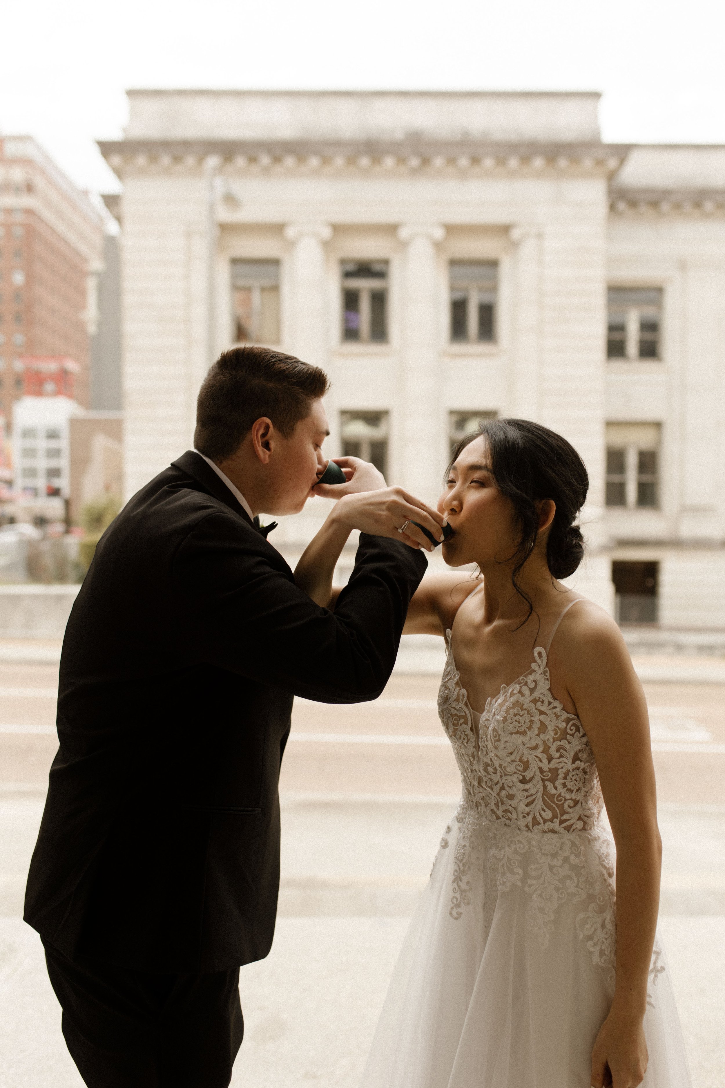 New York City courthouse wedding couple taking a celebratory shot together in their wedding dress and tuxedo