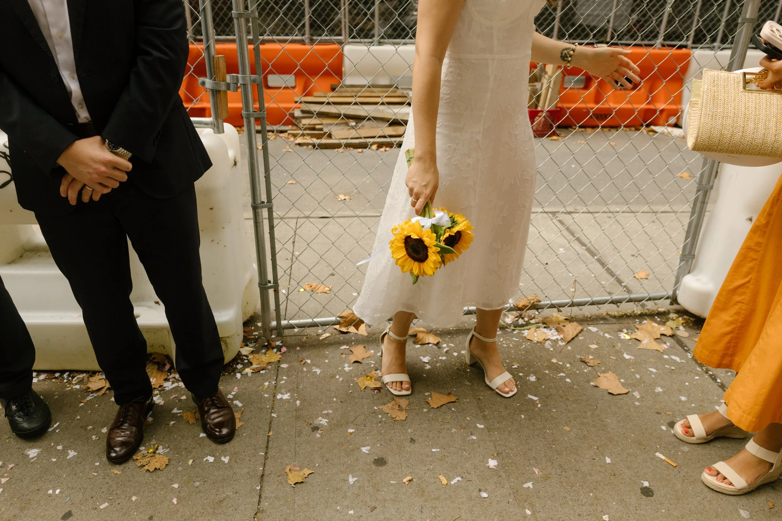 New York City courthouse wedding details with a sunflower bouquet, midi dress, and white heels