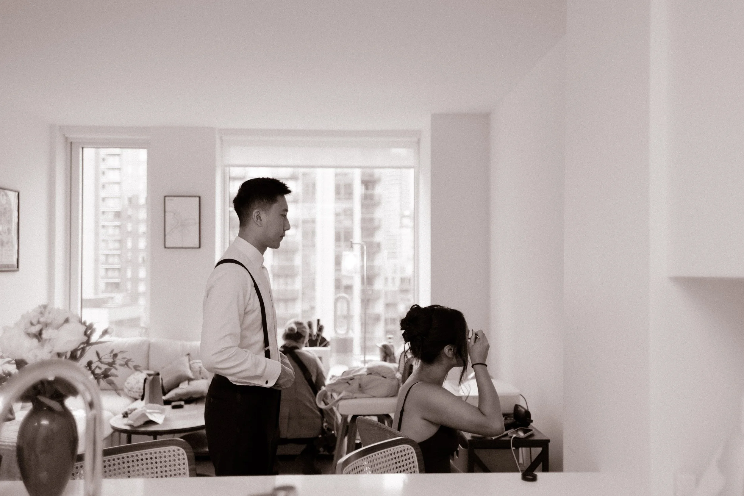 Couple getting ready together in a New York apartment before their courthouse wedding