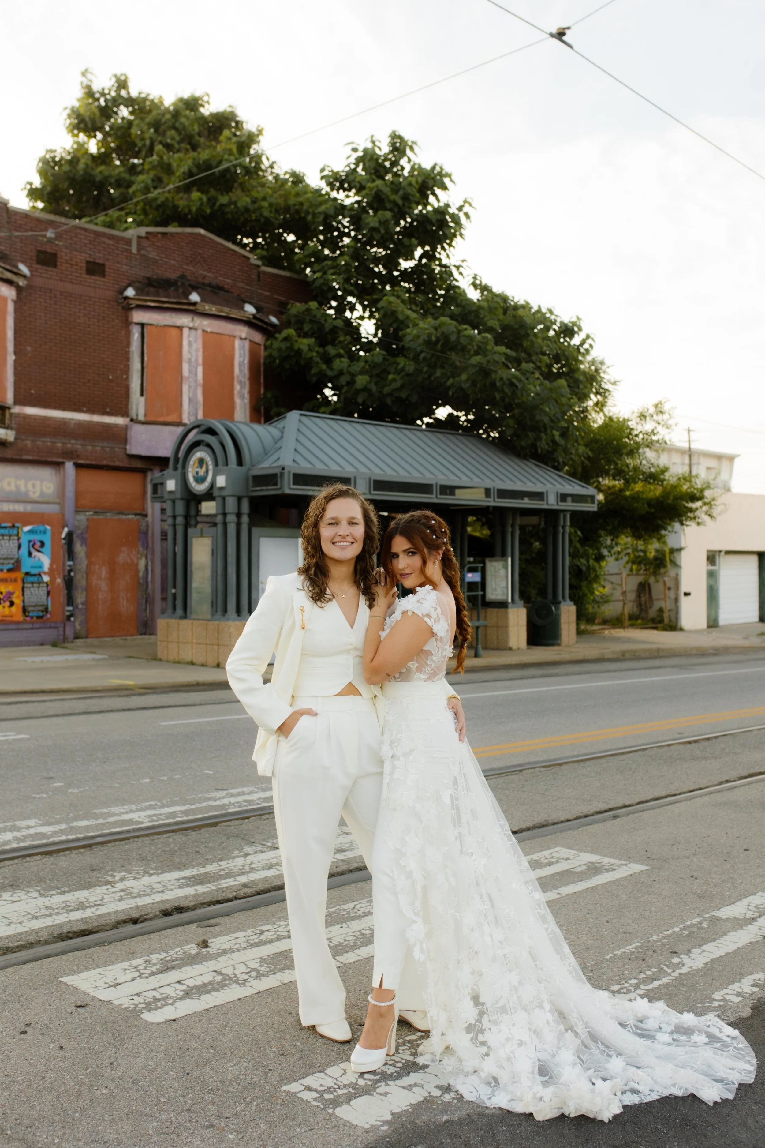 New York City courthouse wedding couple wearing a lace dress and white suit while posing together in the street