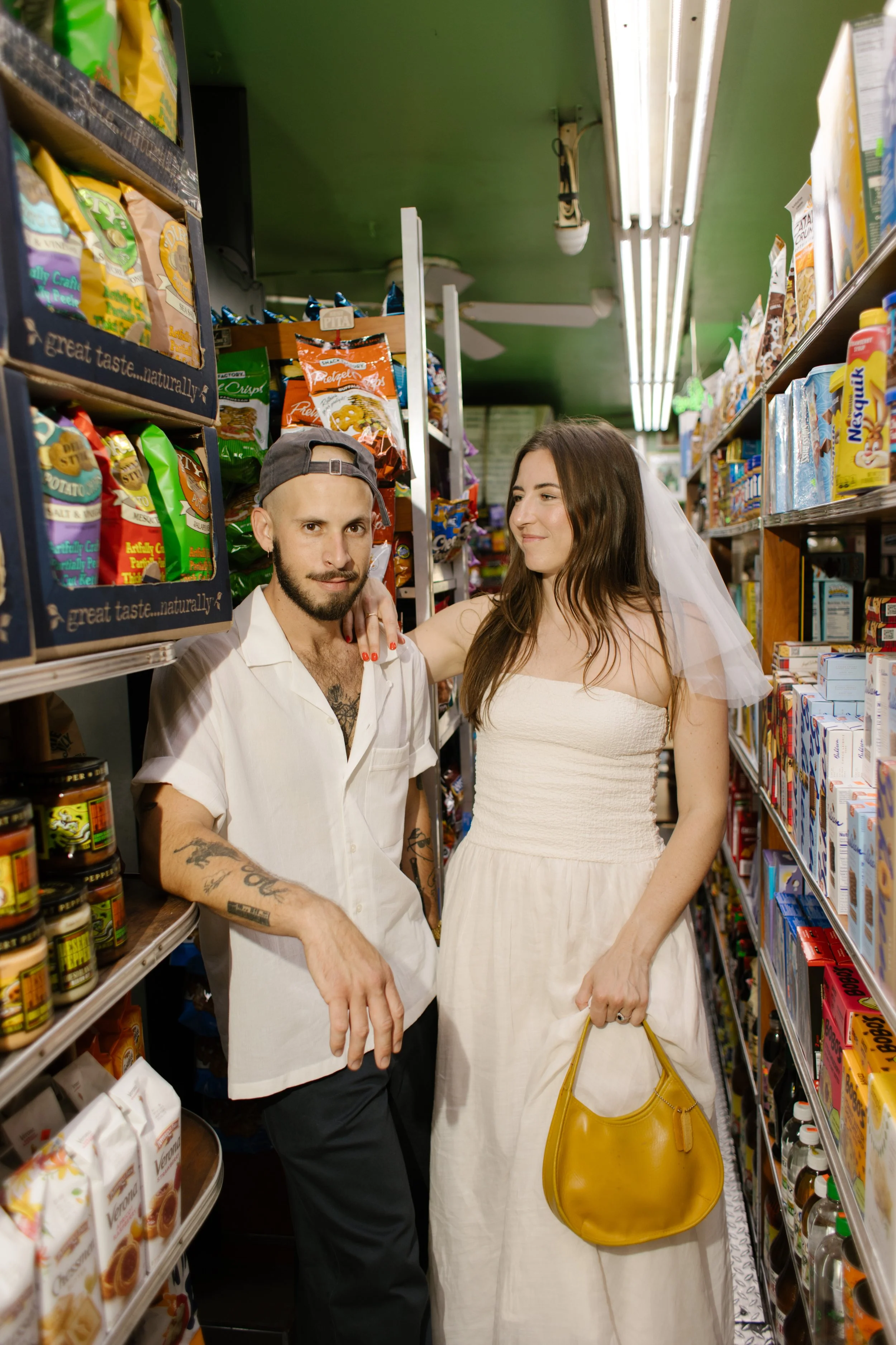Bride and groom inside a neighborhood bodega, proving wedding locations in New York can be fun, candid, and uniquely personal.