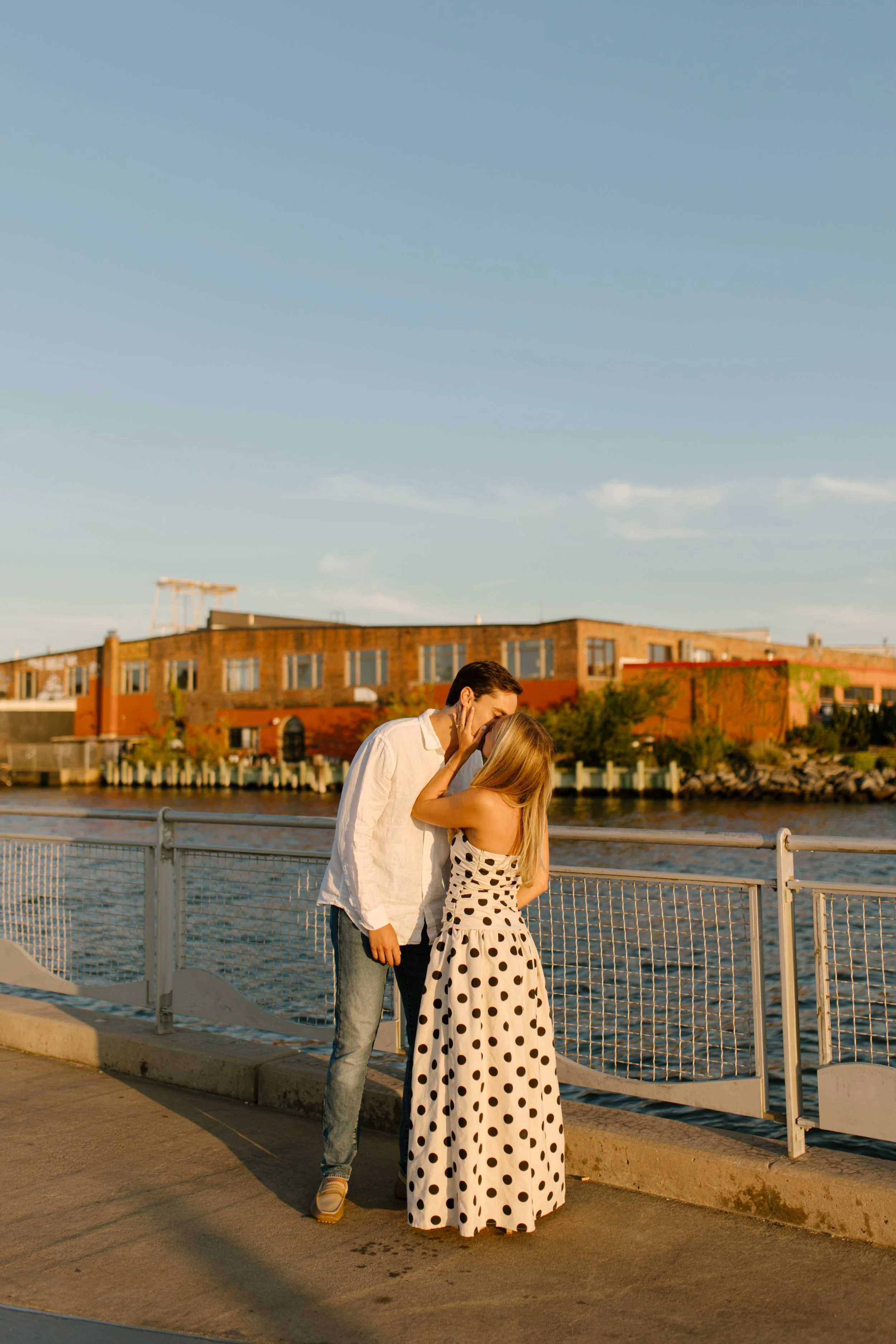 Couple laugh together by the waterfront during a joyful session at one of the scenic wedding locations in New York.
