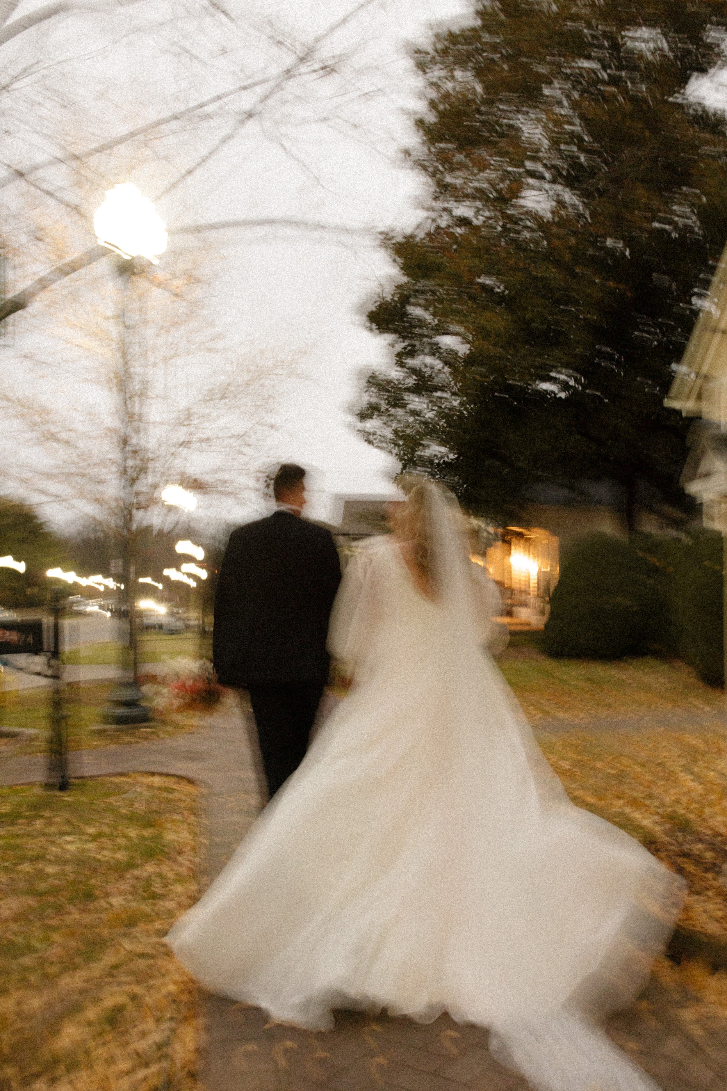 Motion blur photo of newlyweds walking together through Franklin, Tennessee, after their wedding ceremony.
