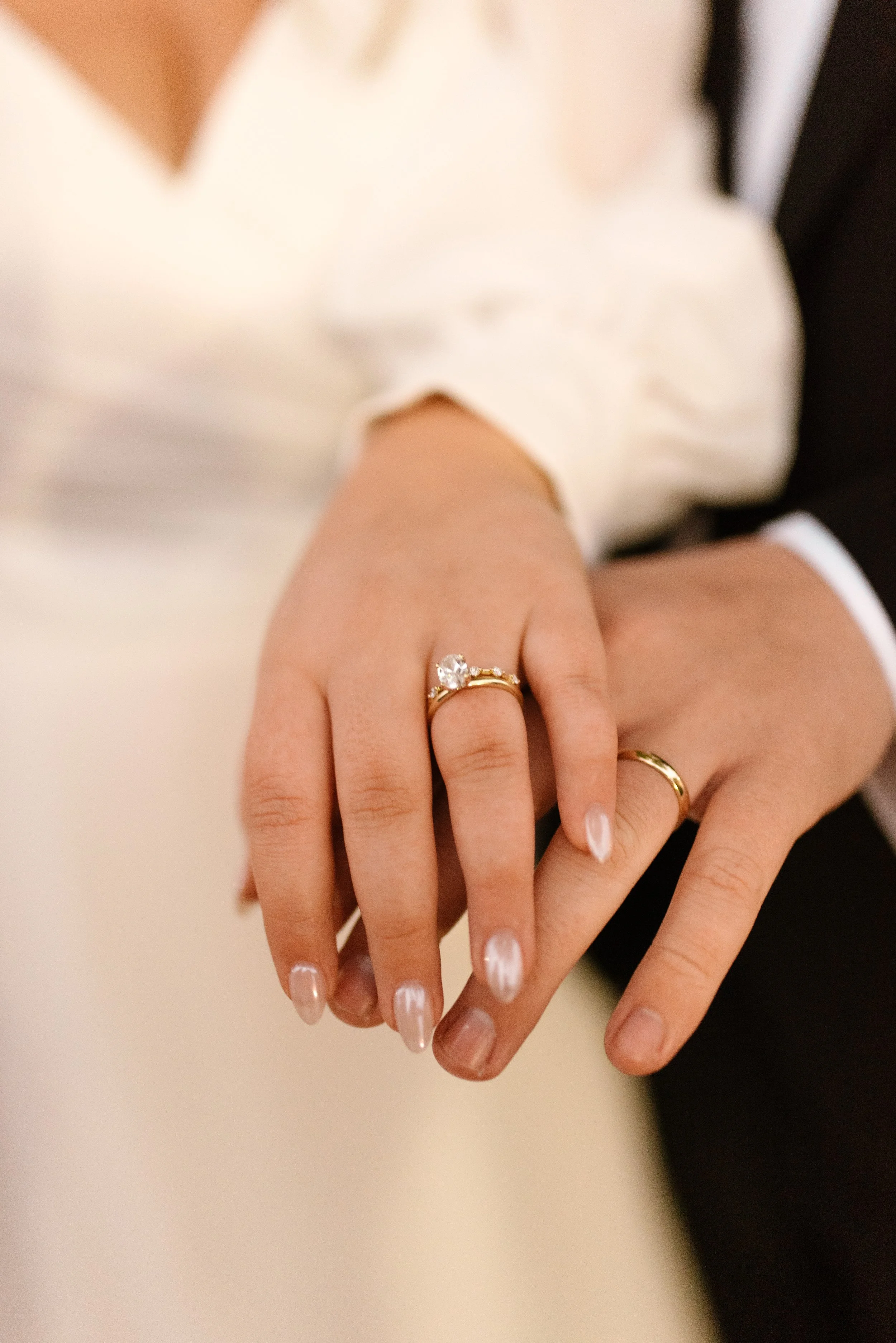 Close-up of the bride and groom showing their wedding rings after the ceremony.