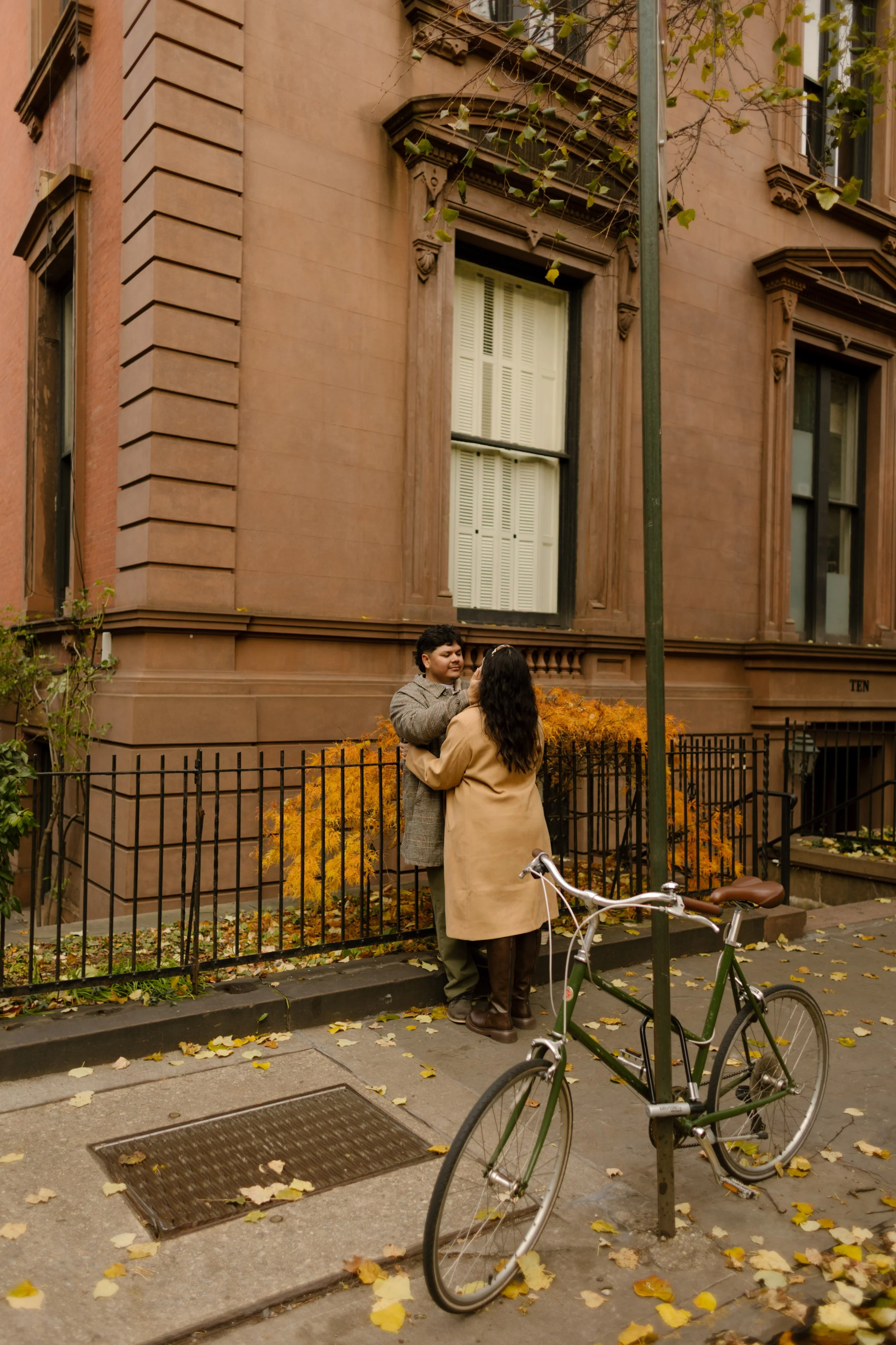 Brooklyn engagement photos featuring cozy fall outfits, coffee, and a couple holding hands while walking through the city.