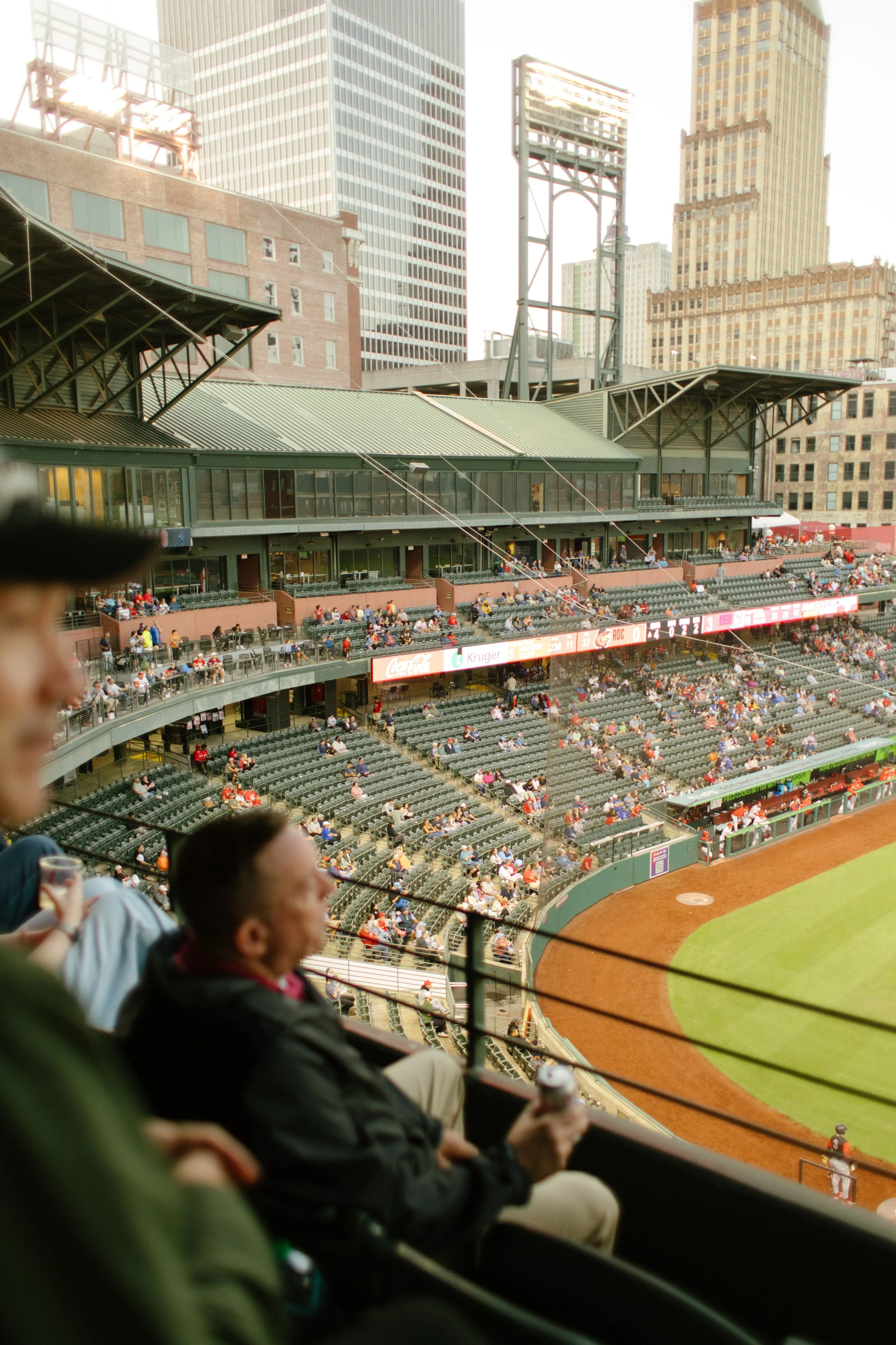 Candid view of guests enjoying a baseball game from elevated stadium seats, capturing the relaxed atmosphere that inspires fun engagement photos.
