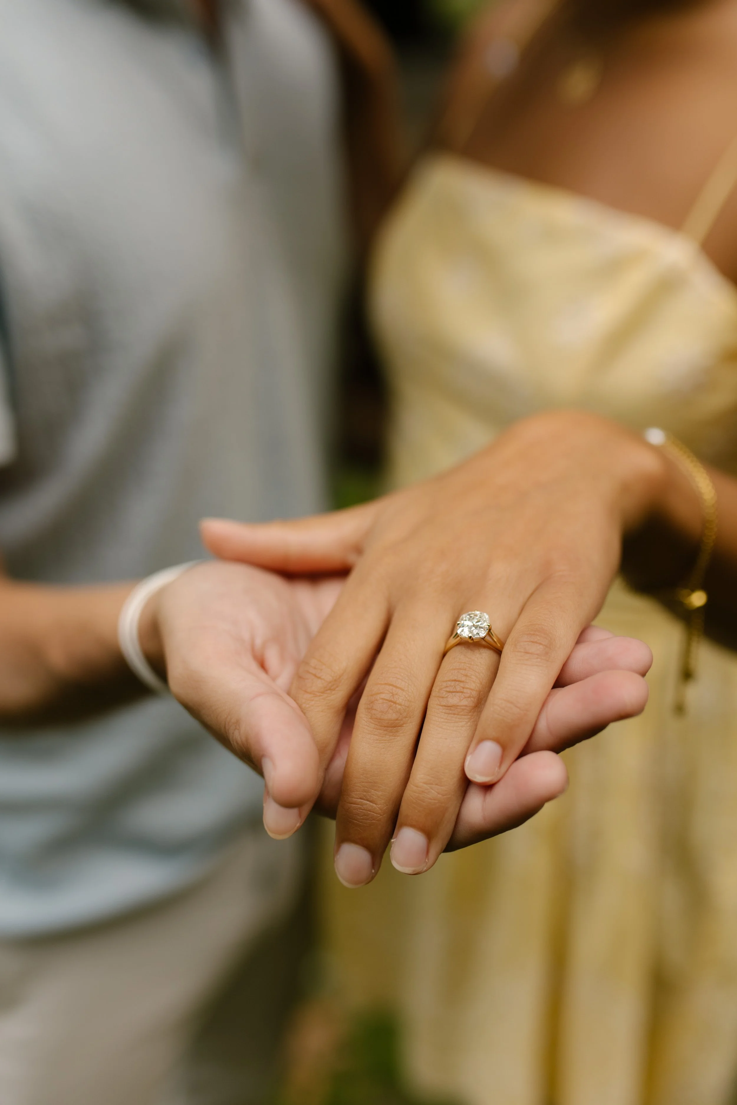 Close-up of Sienna's diamond engagement ring resting on Chris's open palm following their intimate new york proposal in Central Park.