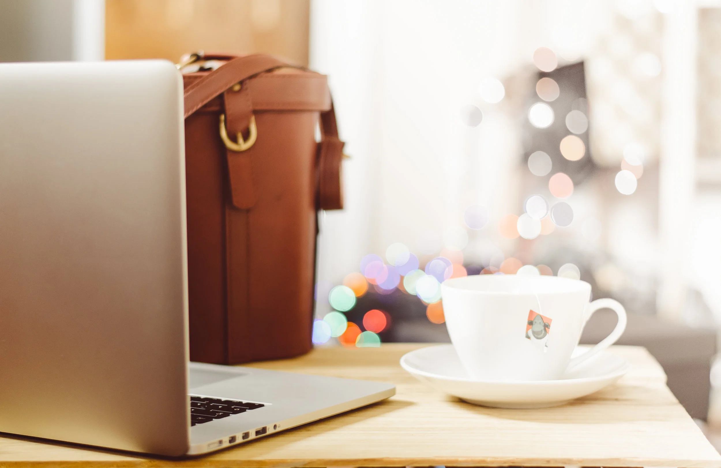 An image of a laptop and a cup of tea to symbolise the operations and business procedures at Hygge Me Global.