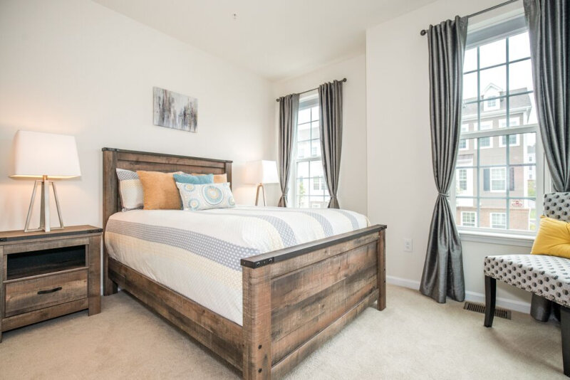 spaces-that-speak-home-staging-woodbridge-nj-wood-bedframe-light-toned-bedroom.jpg