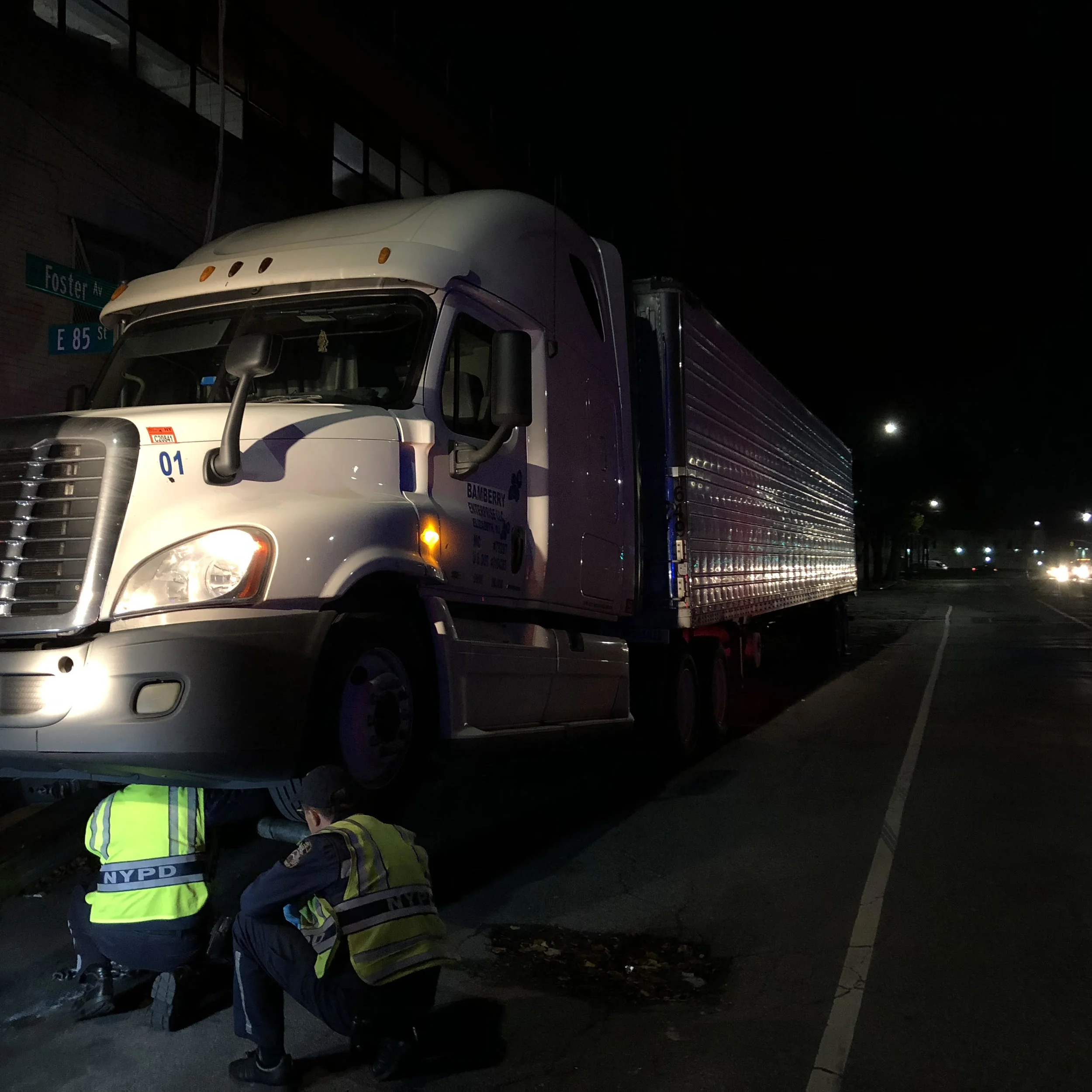 NYPD traffic-enforcement agents prepare to tow a tractor-trailer parked on the service road.
