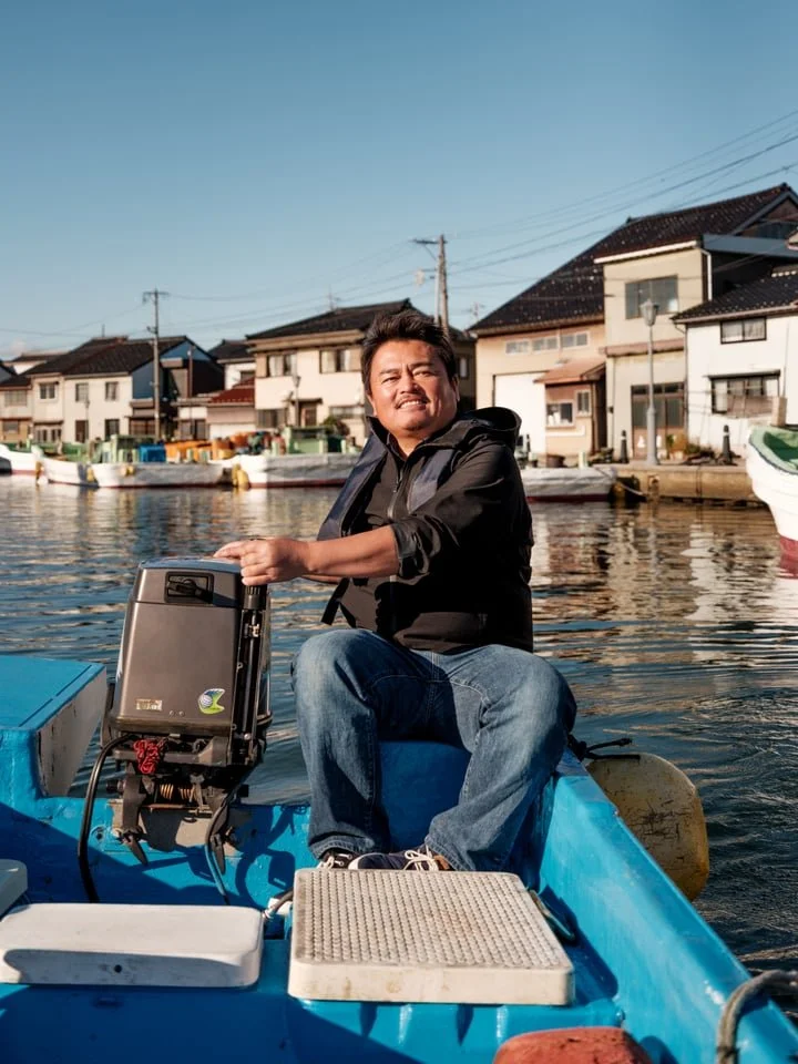 A local fisherman drives his boat along a canal in rural Japan