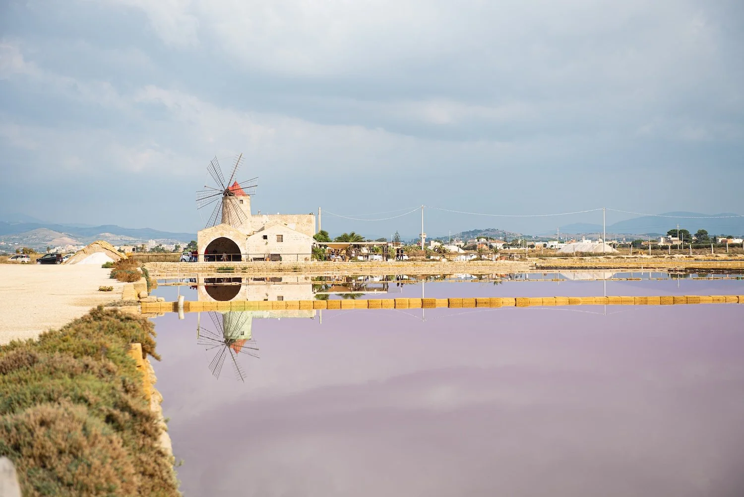 A windmill watched over the pink salt pans of Trapani, Sicily