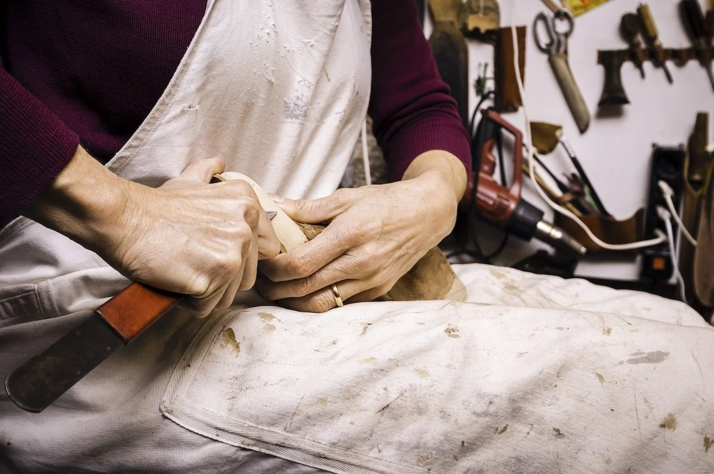 A close up of an artists hands as they work in their studio in Venice