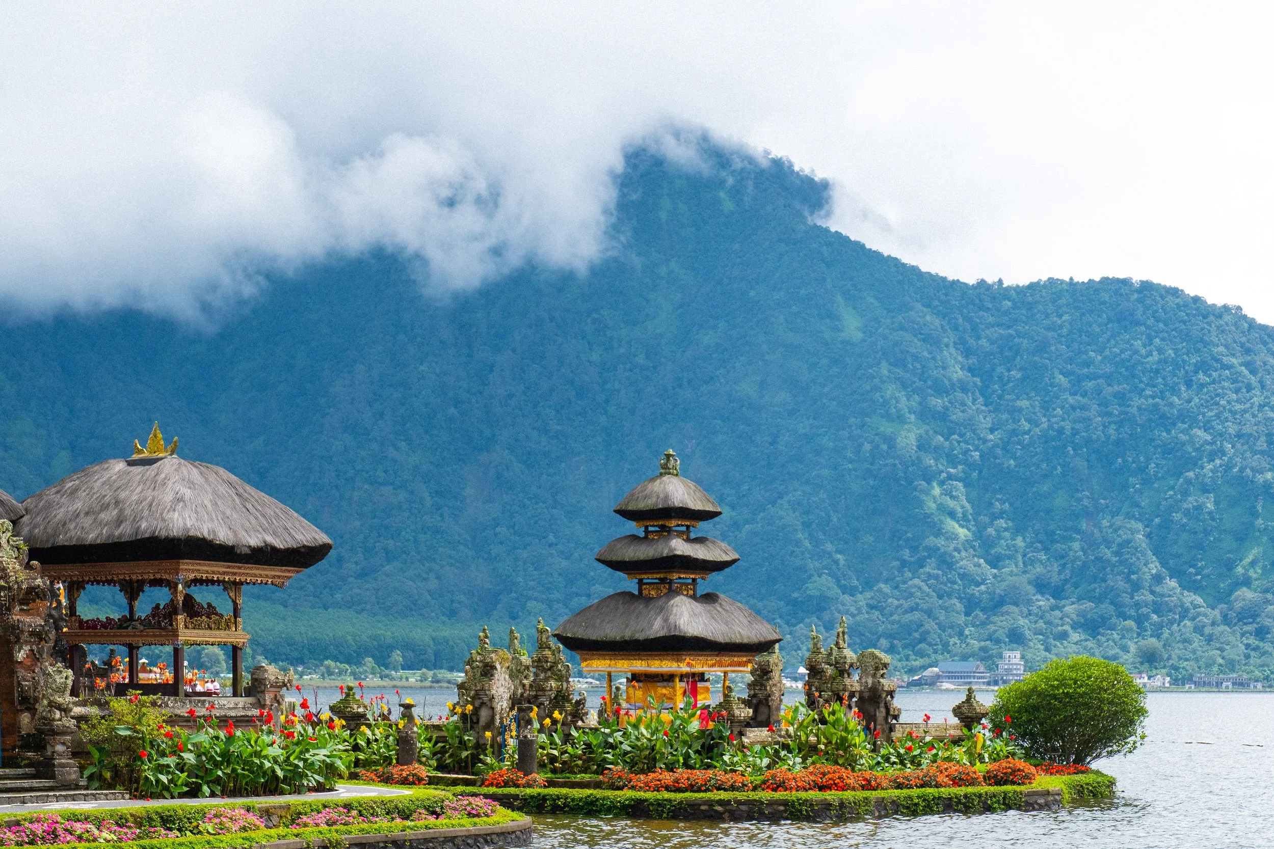 The  mountains of Munduk tower above a lakeside Ulun Danu Beratan