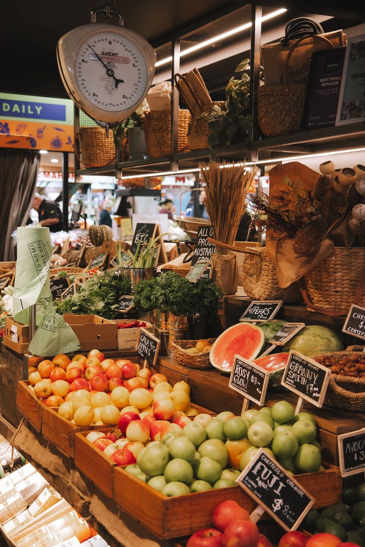 Piled of fresh fruit on wooden trays in a stall at the Adelaide Central Market