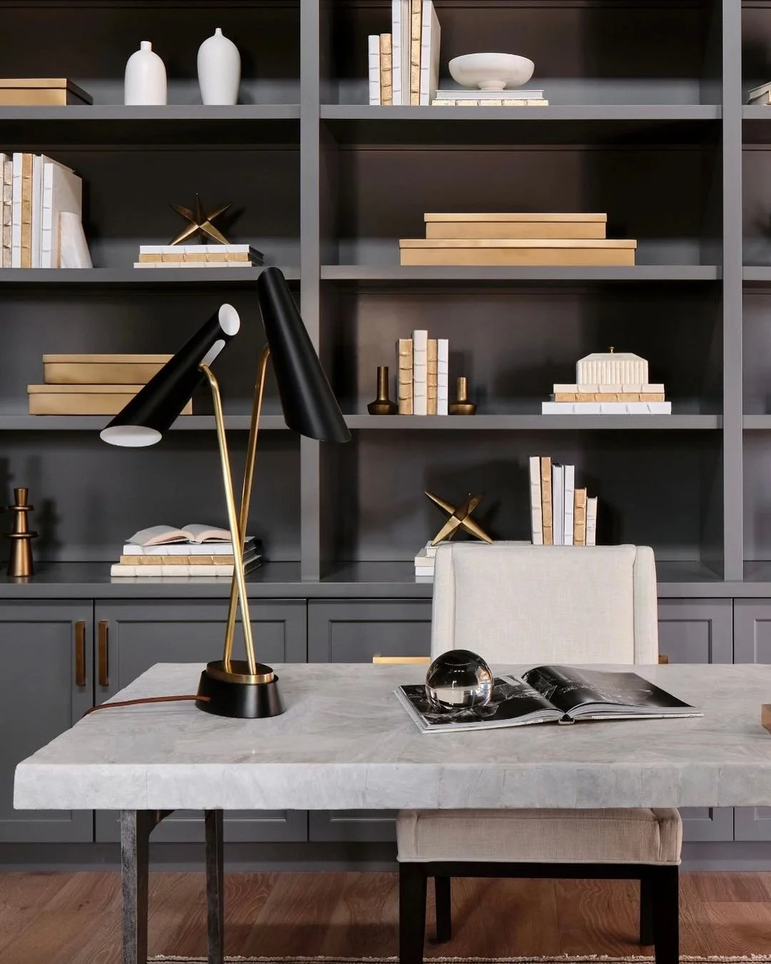 dark gray bookshelf with stone desk in masculine office