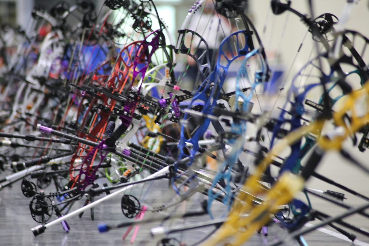 Row of compound bows at Gobbler Classic archery tournament