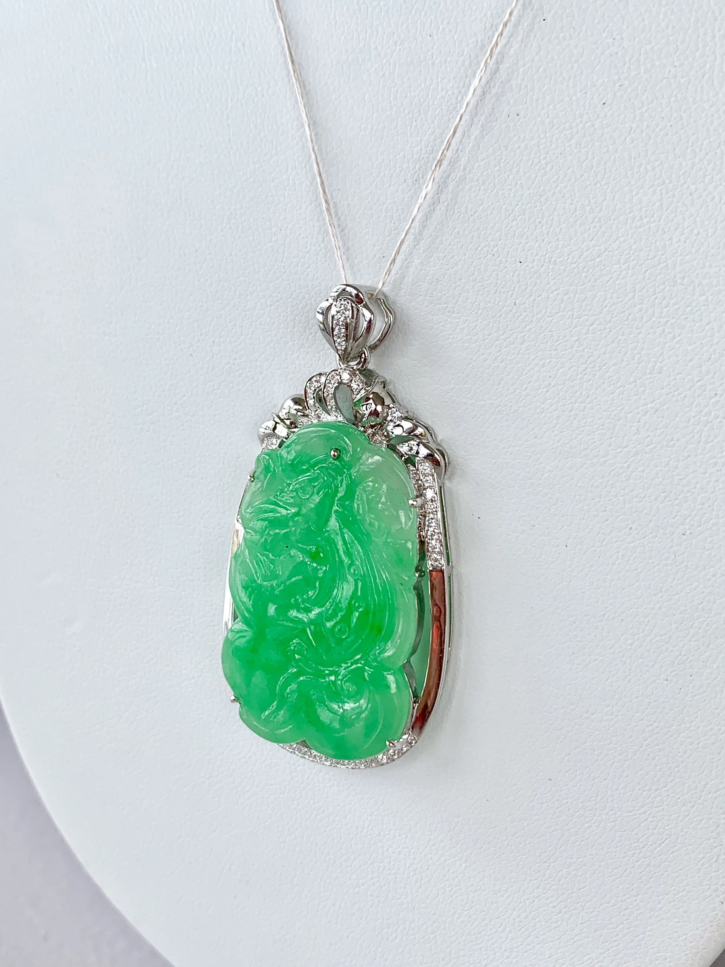 IMPRESSIVE CARVED JADEITE AND DIAMOND DRAGON PENDANT WITH VALUATION