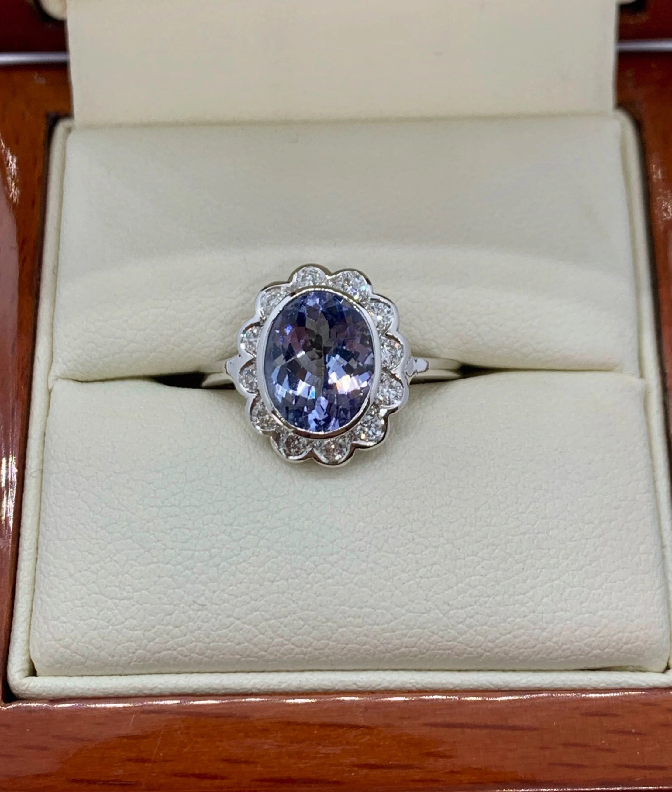 NATURAL TANZANITE AND DIAMOND HALO RING WITH VALUATION AS PICTURED