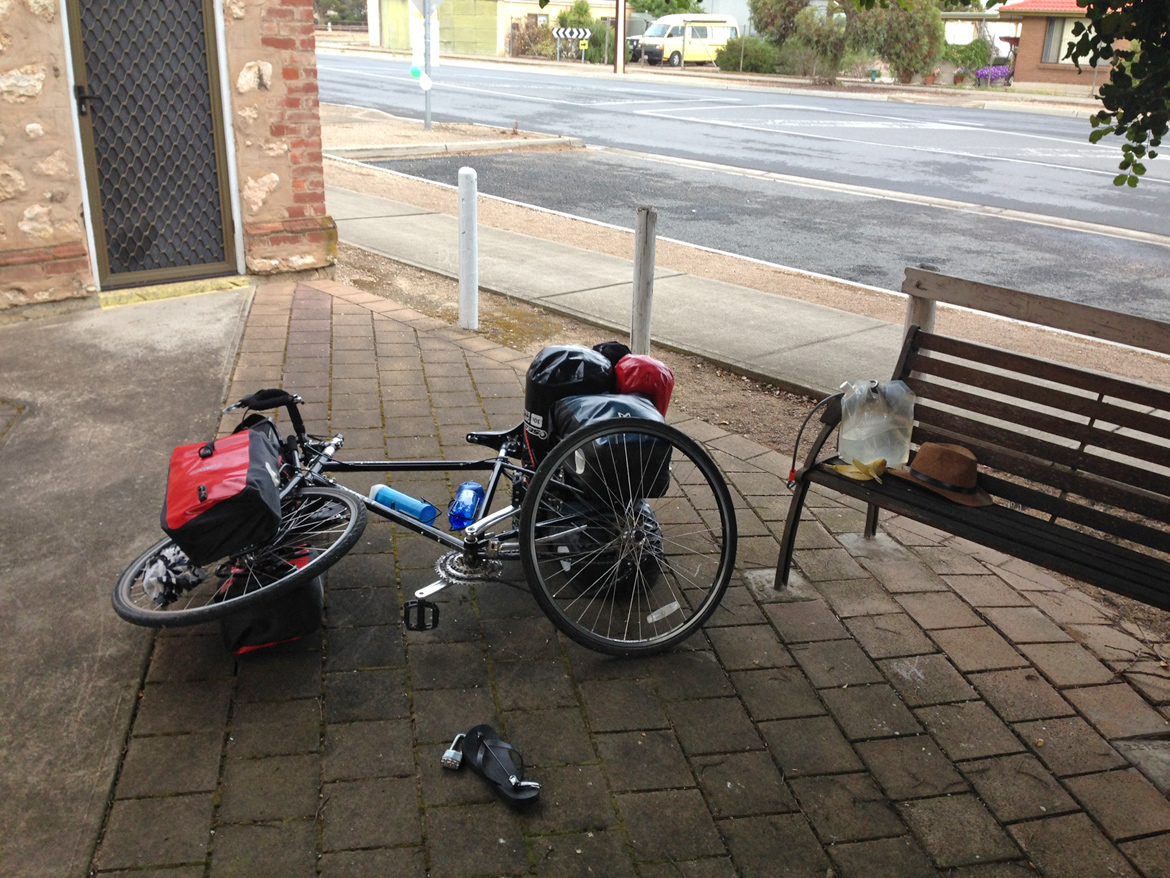  This morning, I could see my rear tyre had a puncture, the first one, of the trip since Adelaide. I changed the tube, and then realized that the tyre was totally gone. The bottom surface of the water bag had brushed with the tyre and the rubber had 