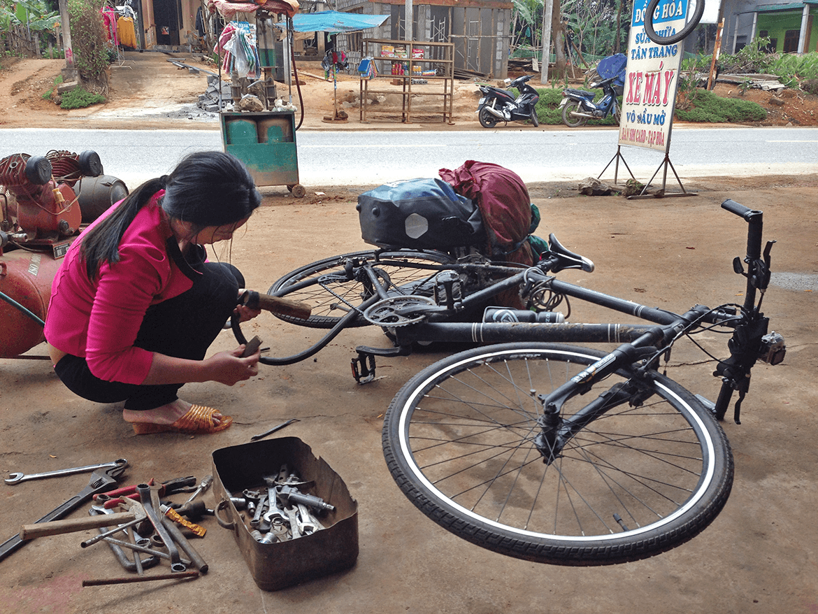  A flat tyre just before Phong Nha, and this lady fixed it very fast. 