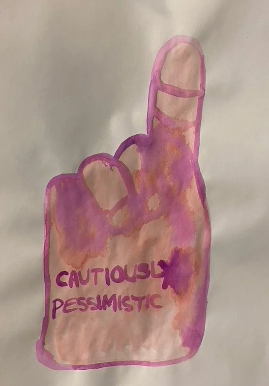   A single watercolor sketch on white paper features a quick drawing of a foam finger that reads "cautiously pessimistic.” It is mostly peach in color but also has a purple-ish pink. The two colors bleed into each other slightly obscuring the text.  