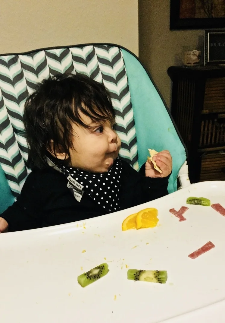 Here Lennox is eating kiwi, salami, and oranges. I kept the peel on the oranges so it’s easy for Lennox to hold. He is about 7 months old in this picture.