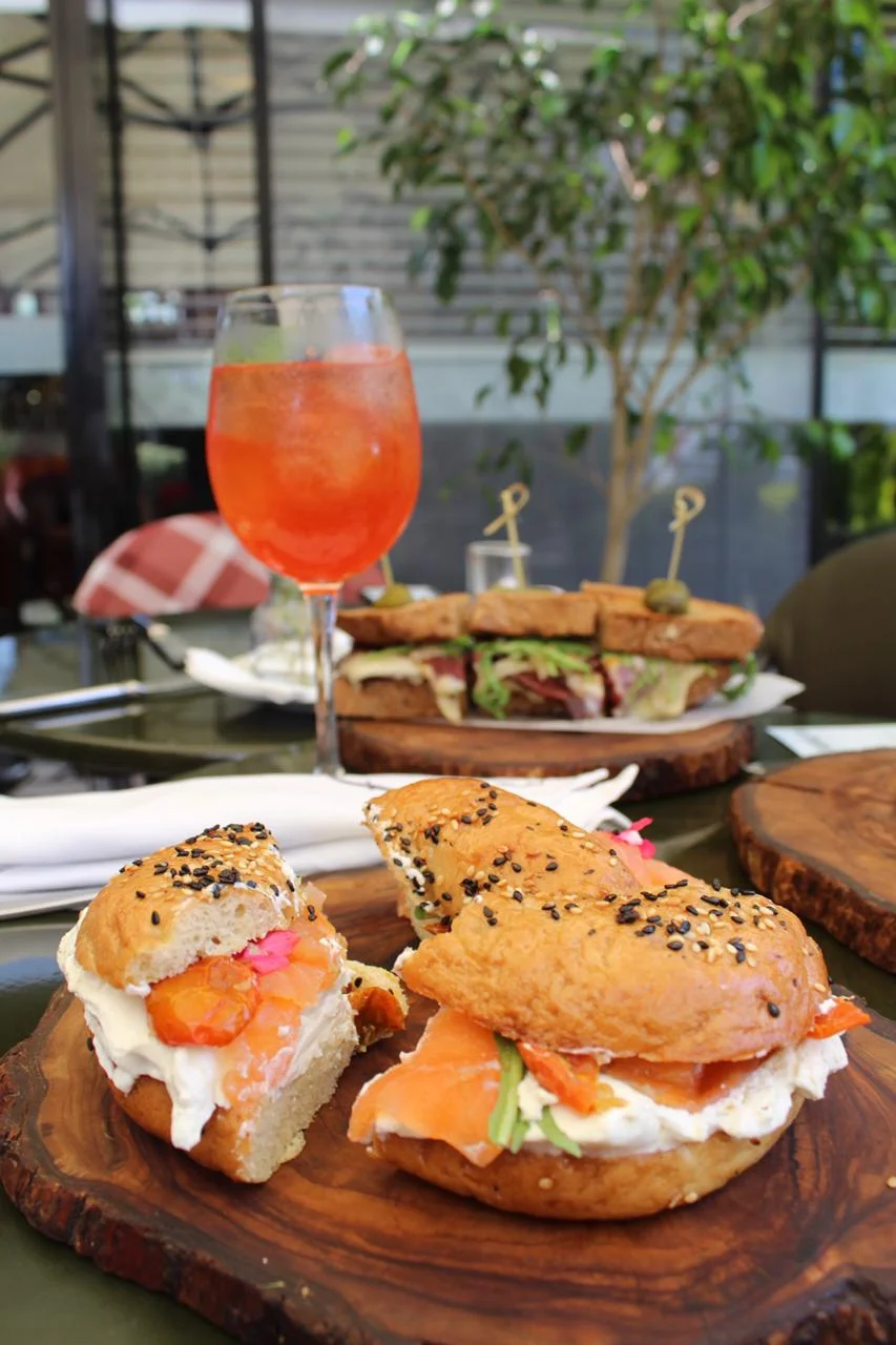 Lox ‘n Bagel, parted in 3 for sharing purposes pictured with the Eleanore and pastrami in the background