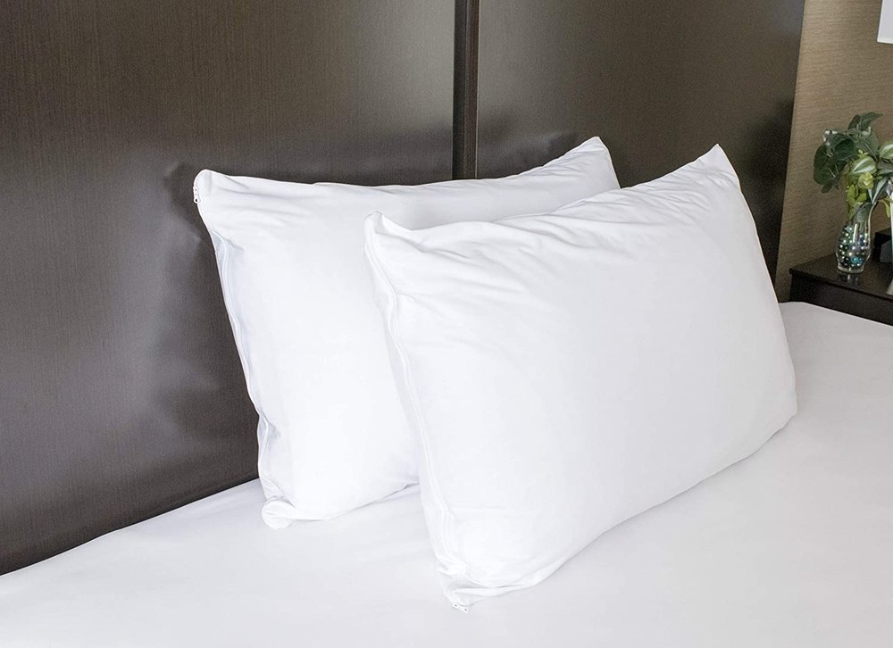 Four Seasons Allergen-Proof Pillow Covers. Two white pillowcases on pillows on a bed.