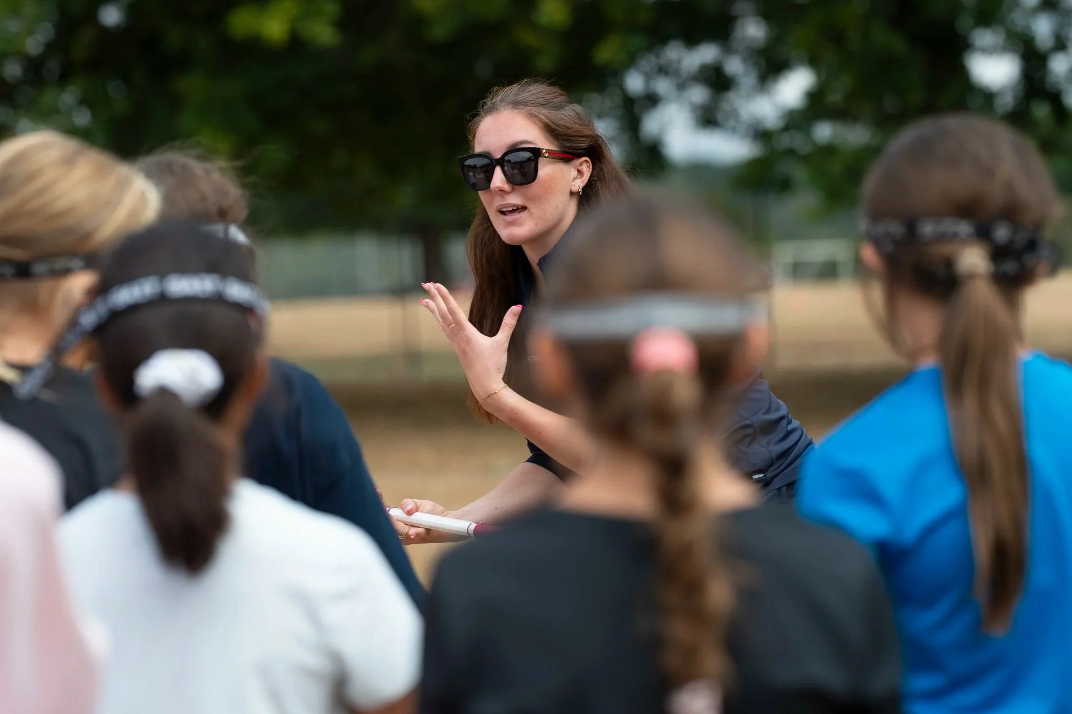 Coach at Triple Arrow Camps speaking to campers
