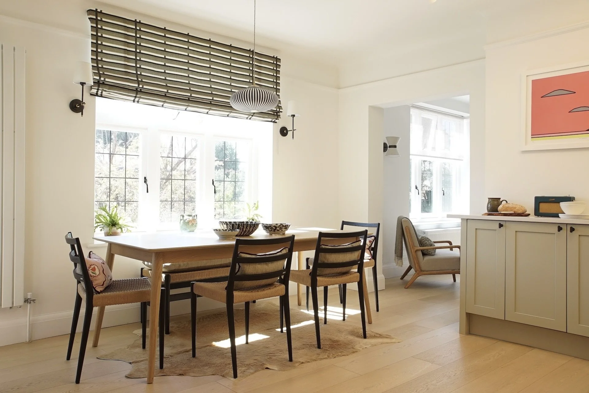 stylish bright kitchen black chairs.JPG