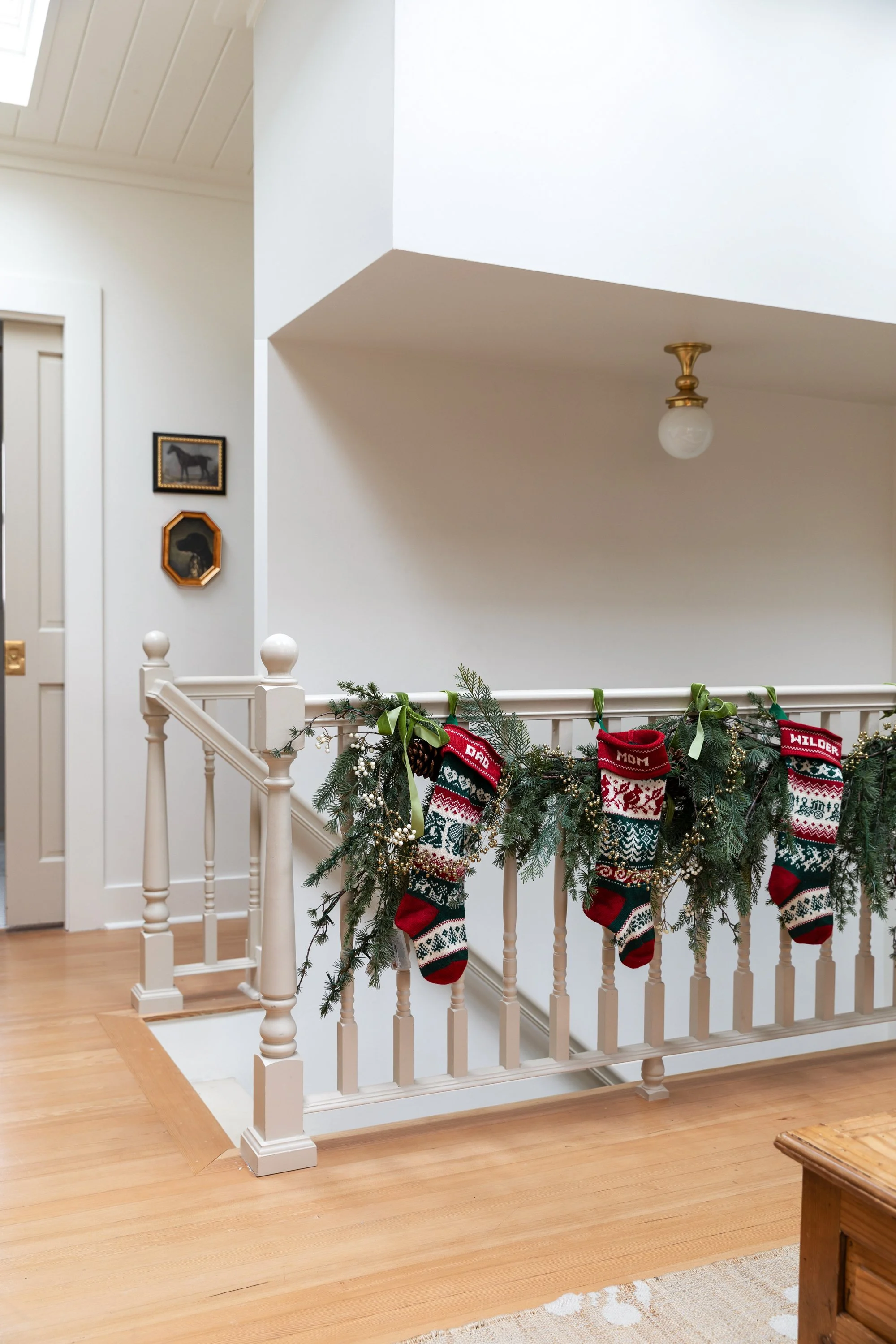 Upstairs landing decorated with garland and stockings at the Poplar Cottage