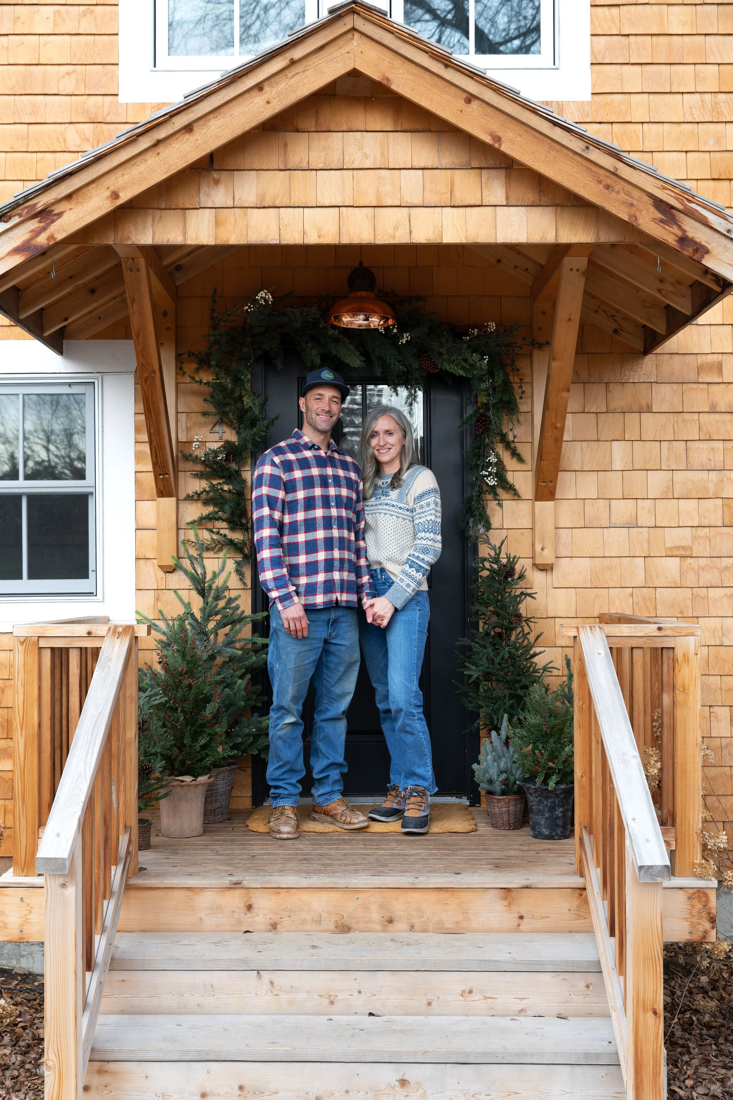 Poplar Cottage front deck with cedar siding and holiday decor and copper light