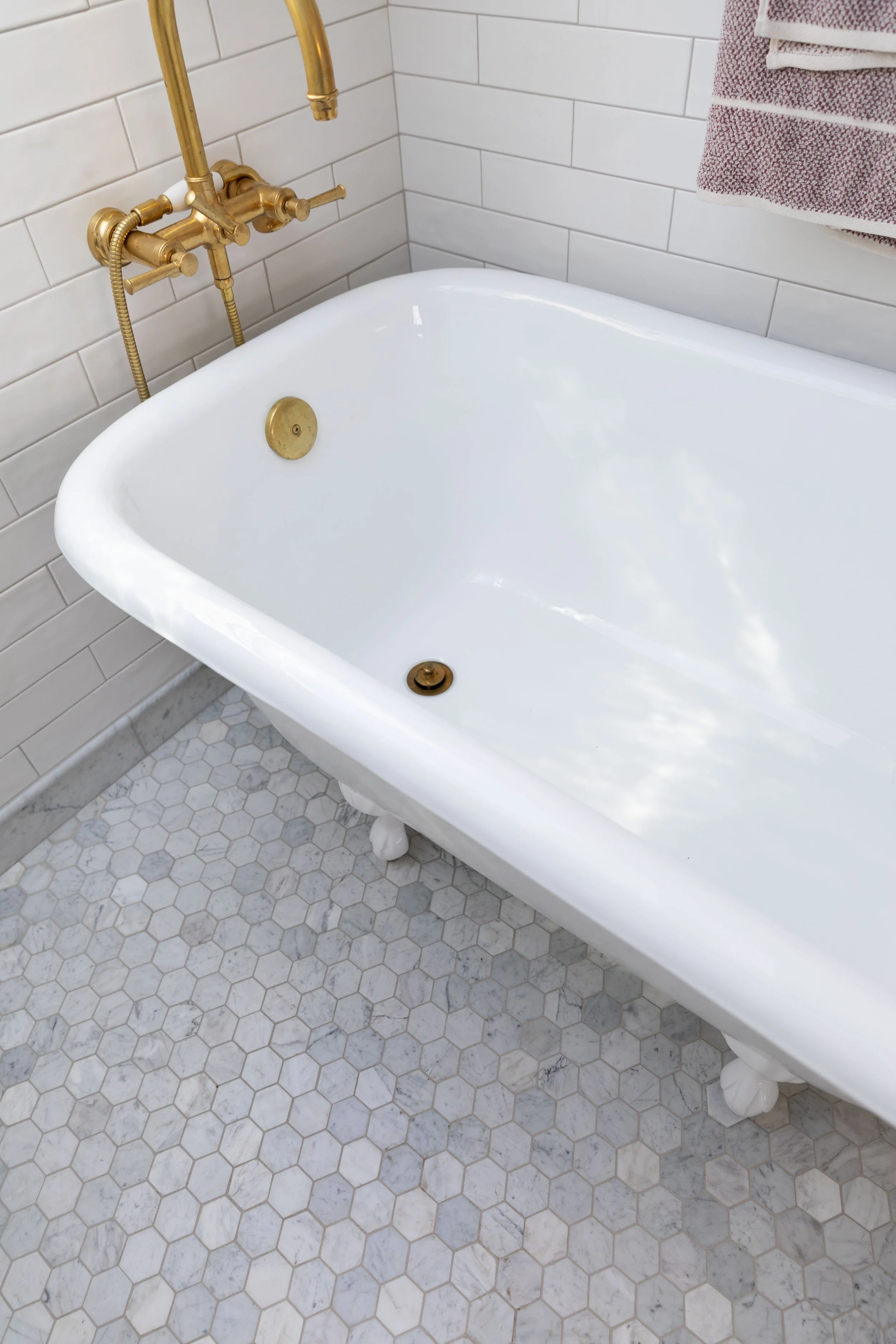 Marble hex bathroom floor with iron-colored epoxy grout in the Hill House ensuite