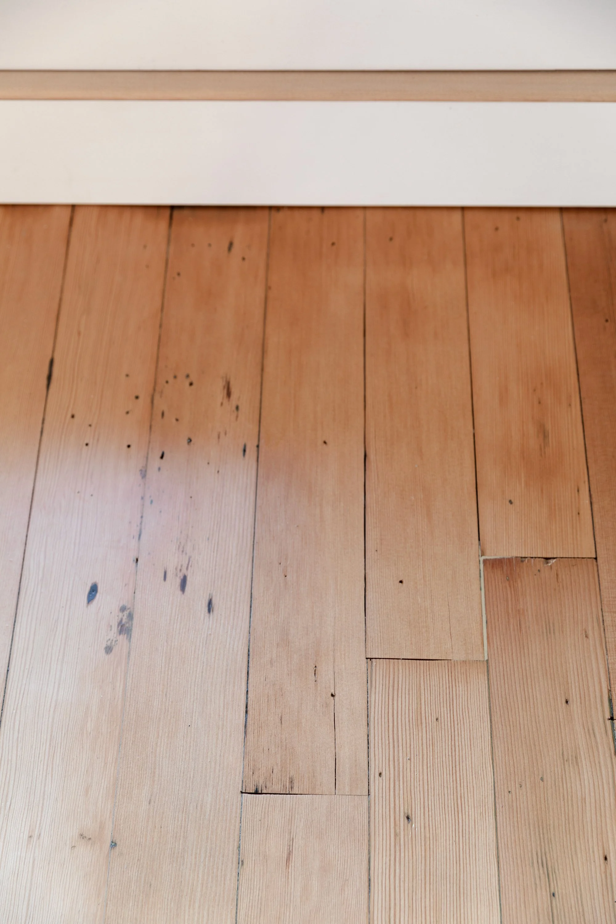 Close-up of staple holes left in original fir floors, adding character after refinishing