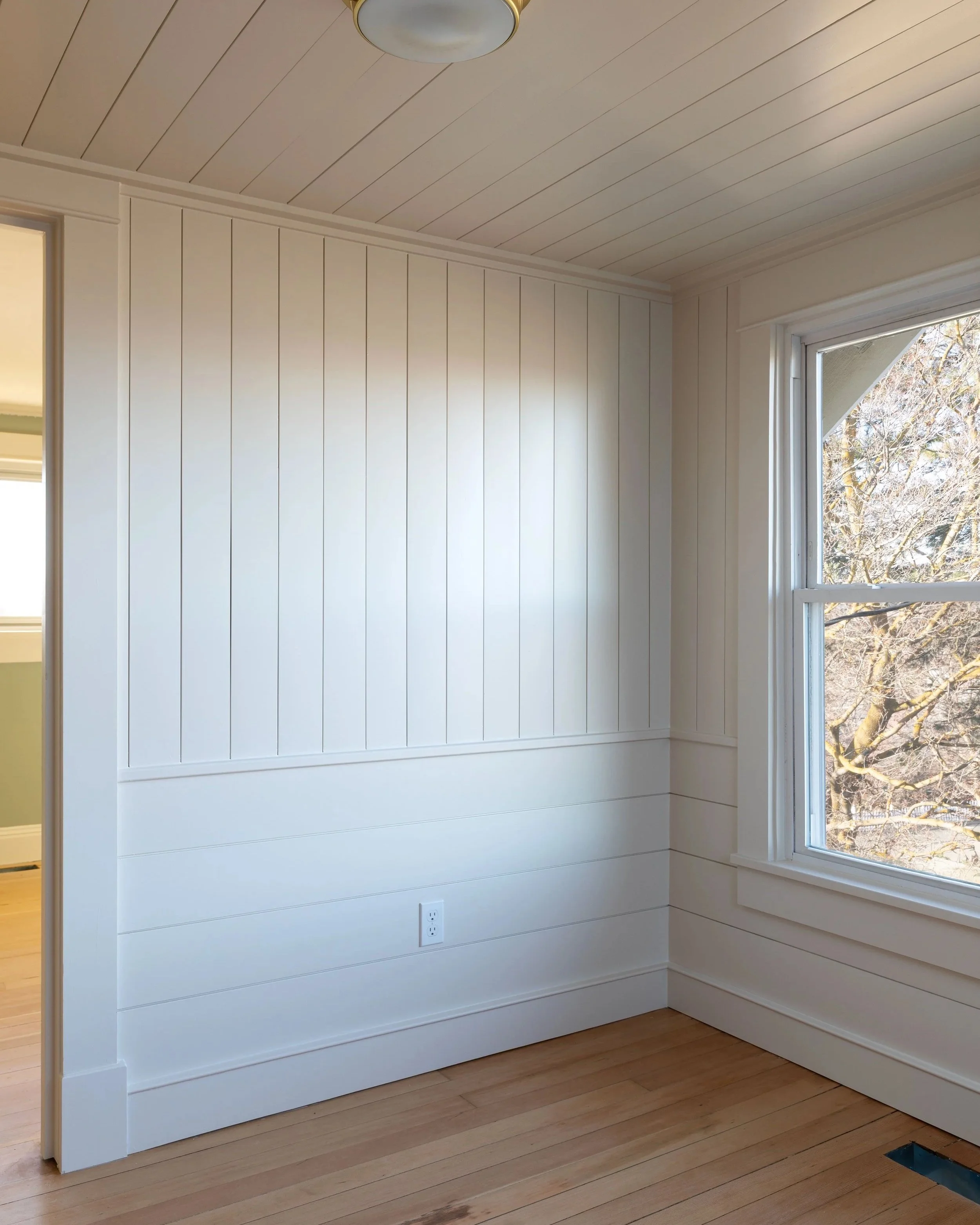 The wall paneling upstairs at the Hill House features nickel gap panels in horizontal and vertical orientations