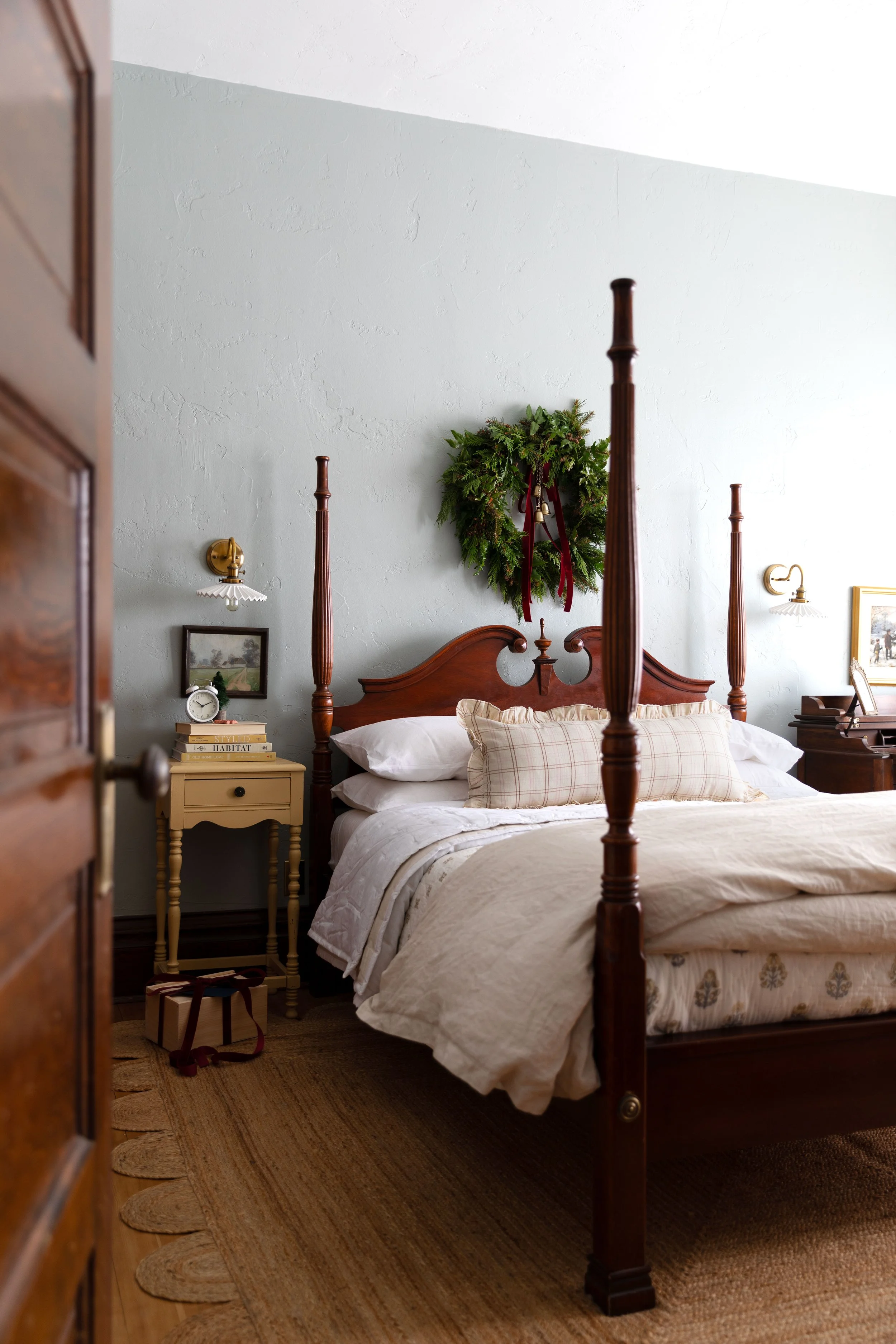 light blue farmhouse bedroom with festive wreath.